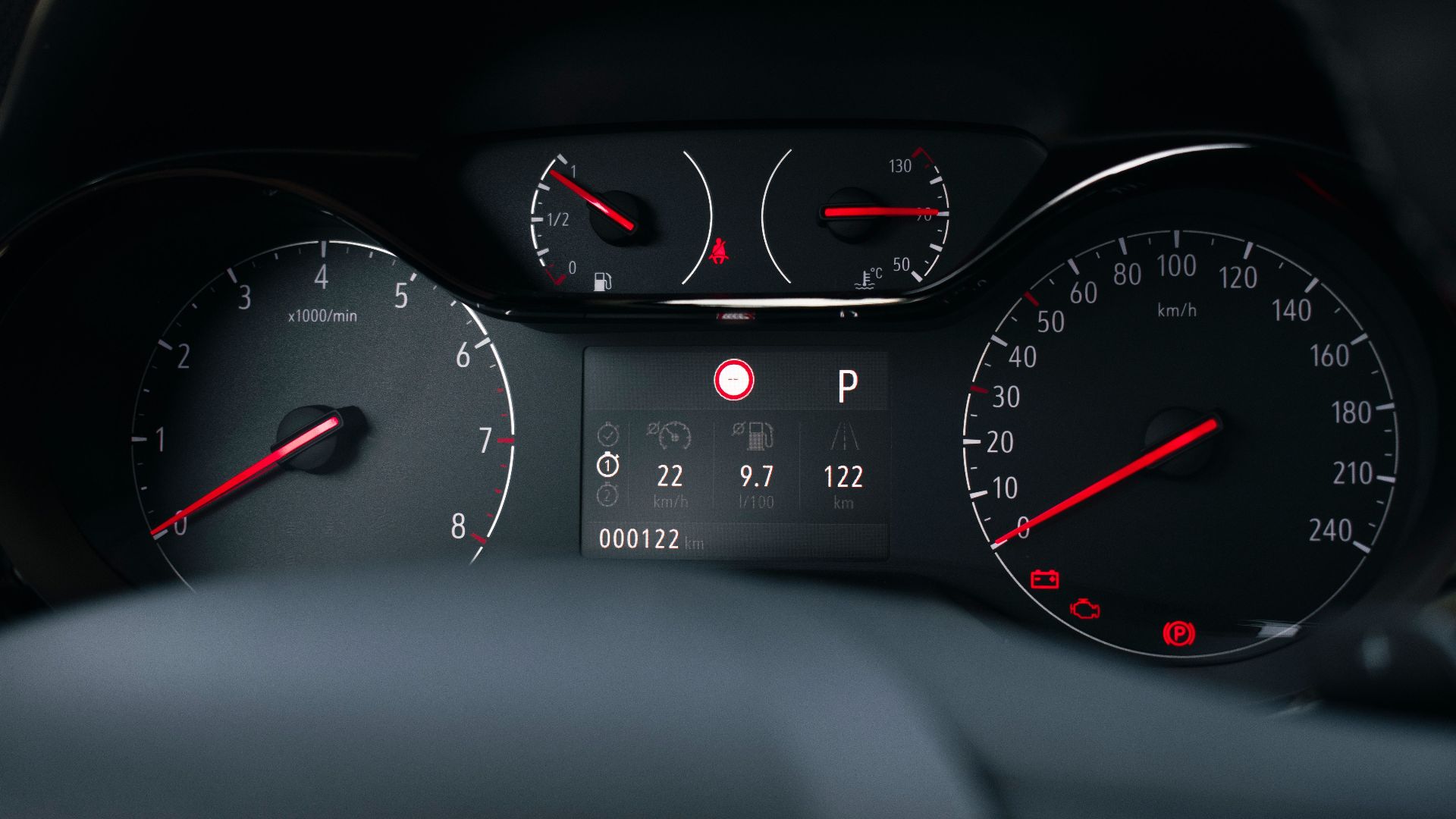 Detailed view of a modern car dashboard with speedometer and fuel gauge indicators.