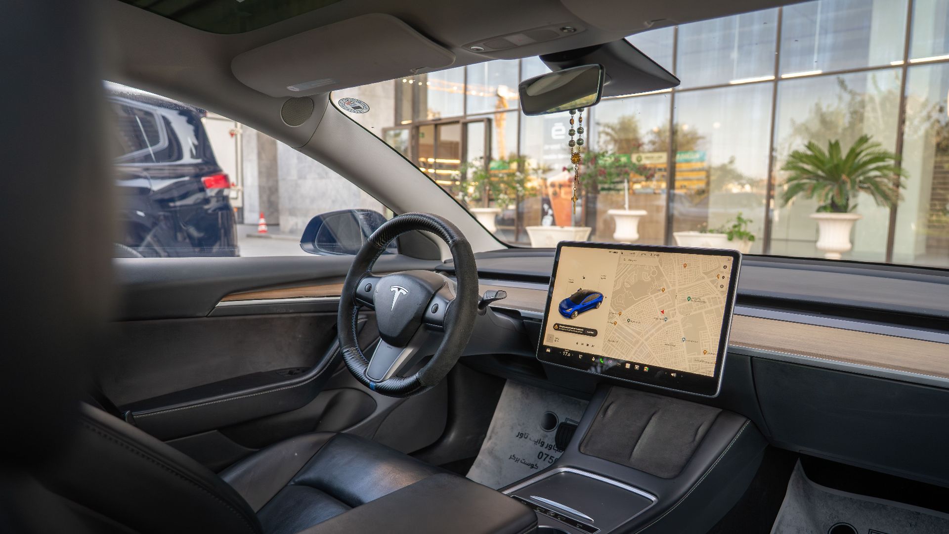 Tesla Model 3 interior showcasing navigation screen and sleek design, ideal for modern automotive themes.