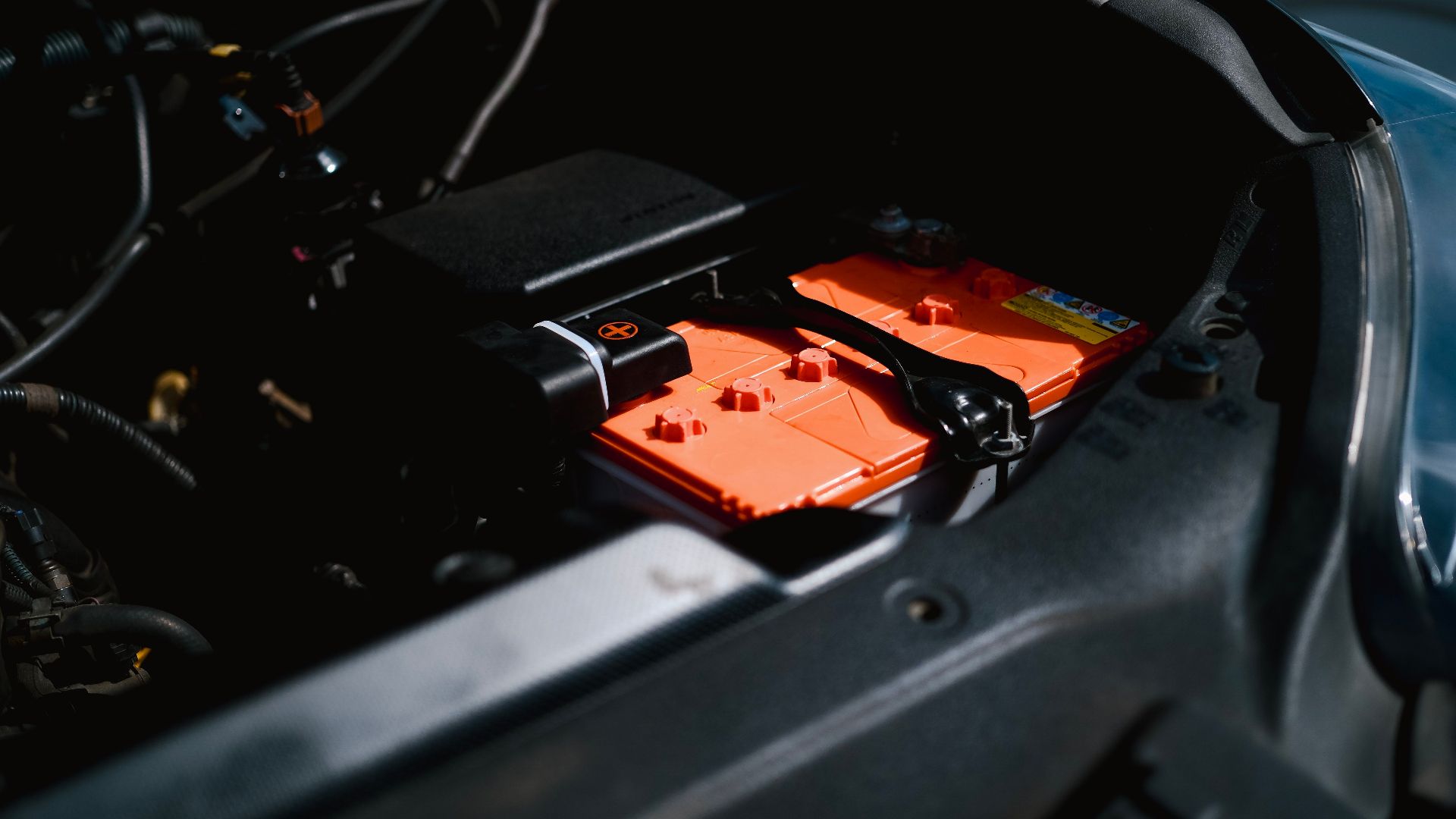 Detailed view of an electric car battery inside a vehicle's engine compartment, highlighting sustainable technology.
