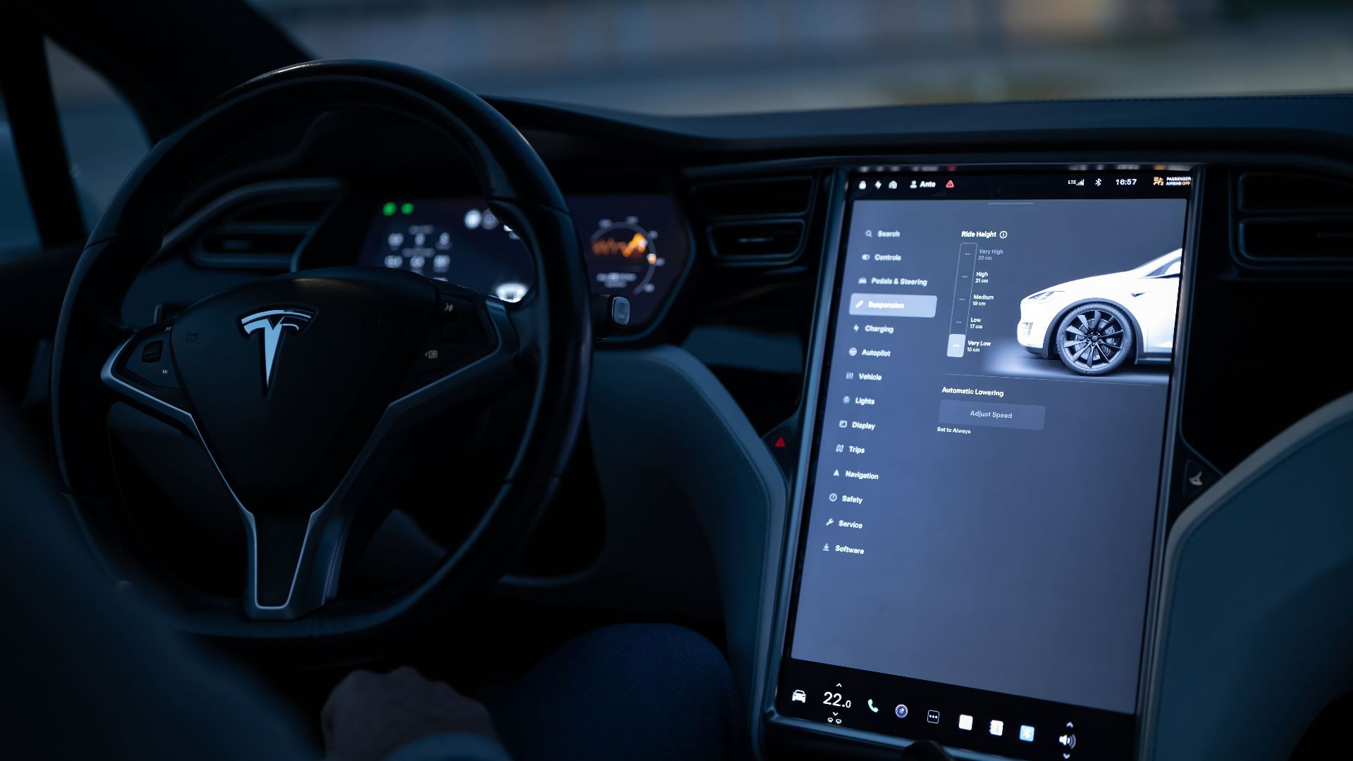 Tesla car interior showcasing advanced touchscreen display and steering controls.