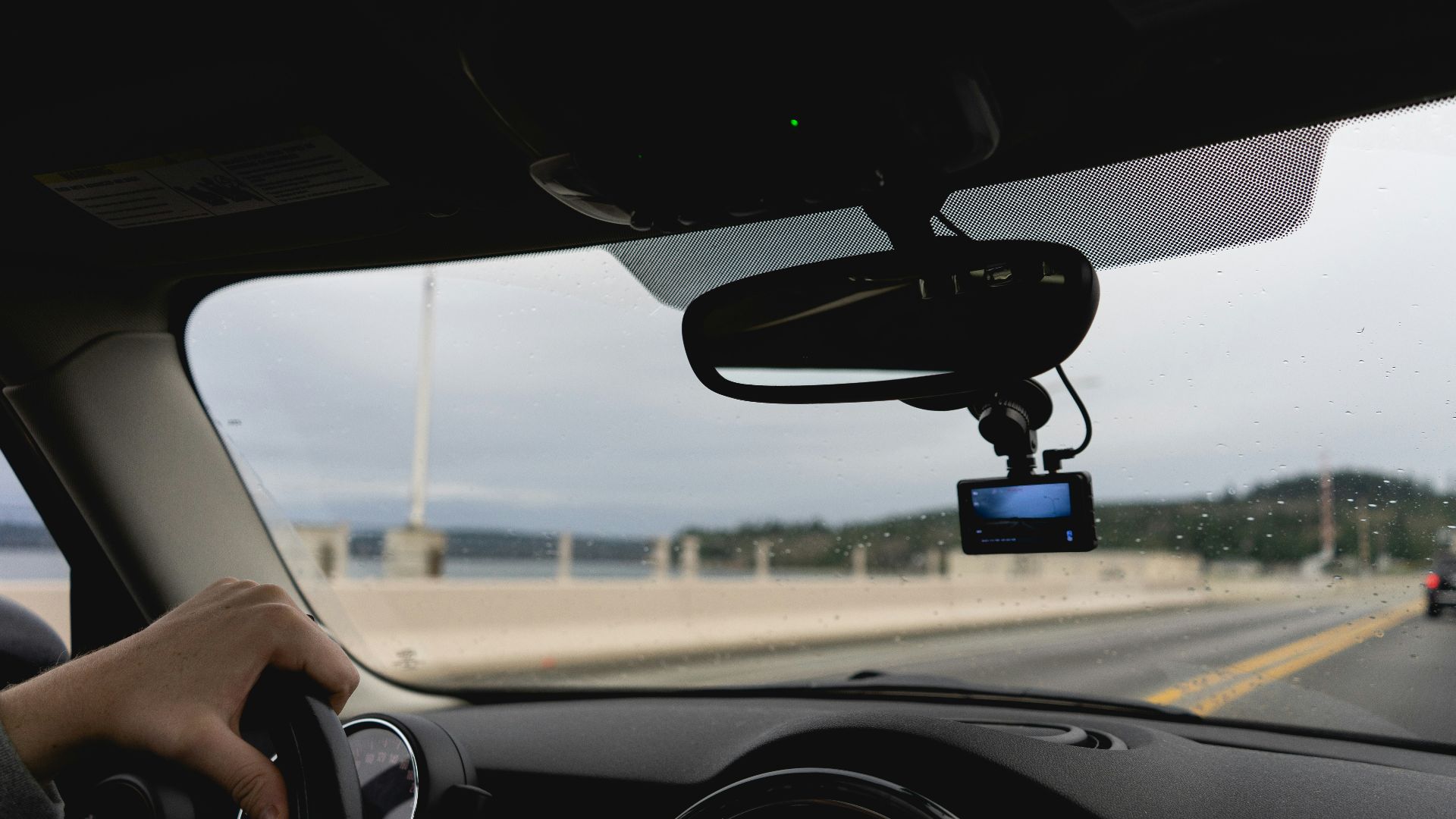 a person driving a car on a highway