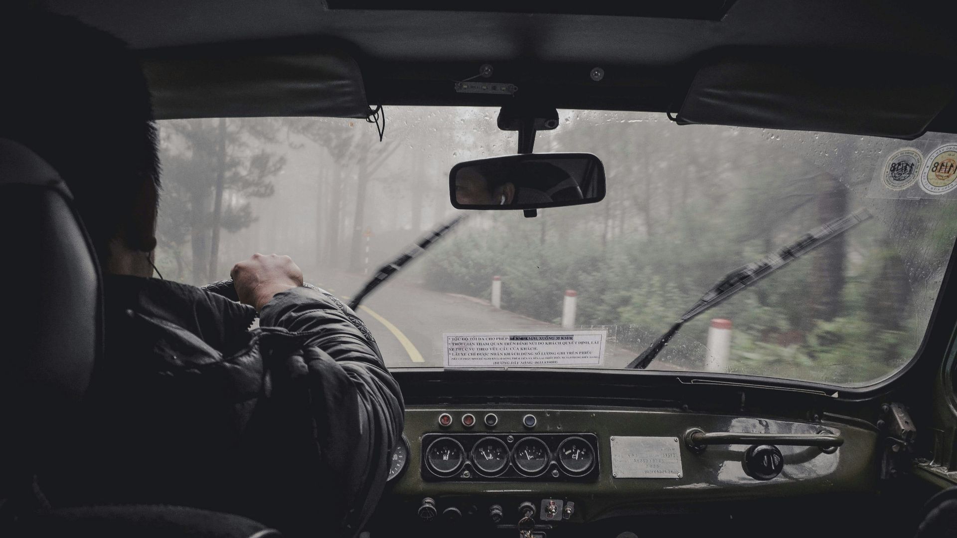 man driving car during rainy daytime