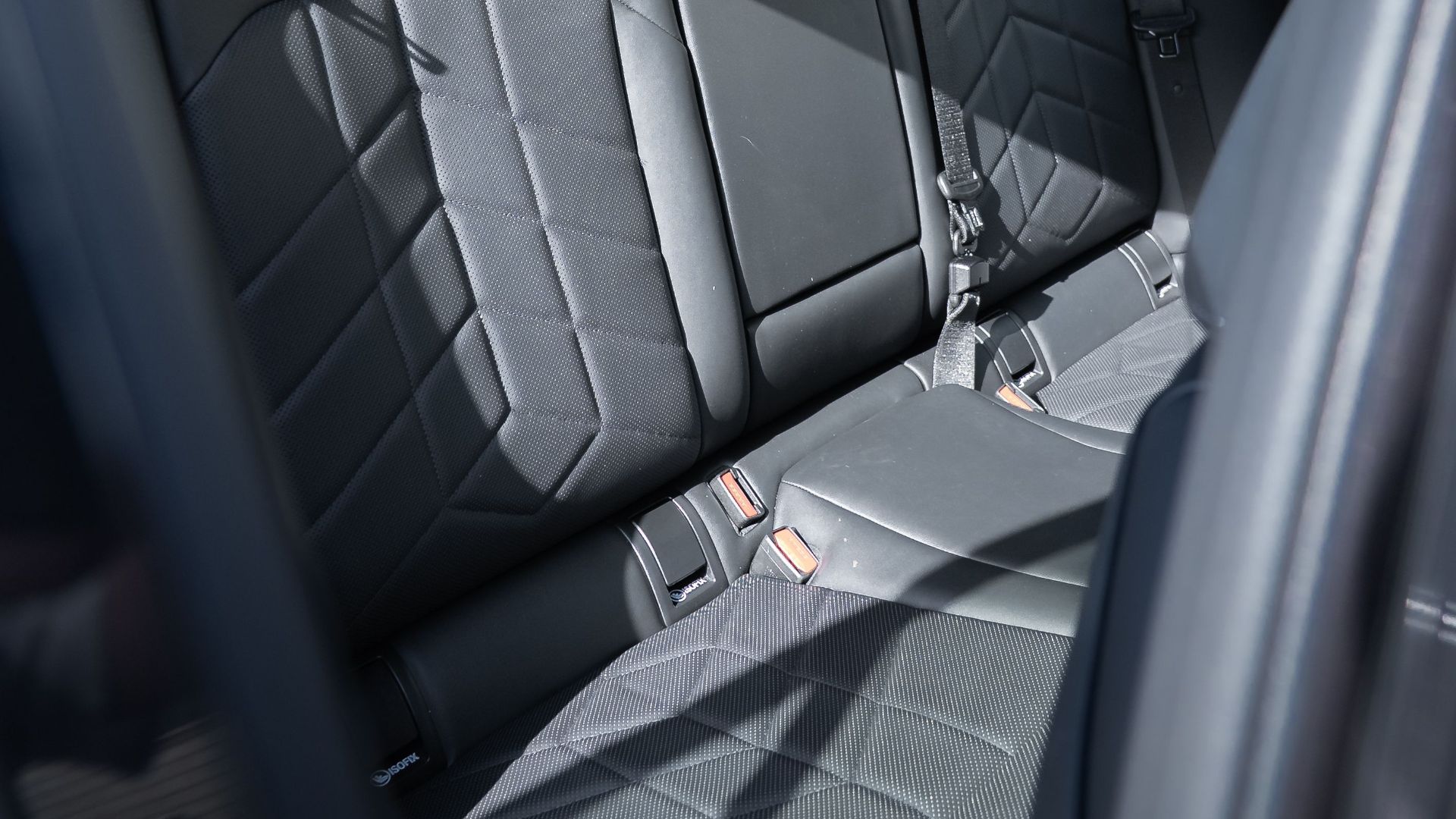 High-angle view of luxurious black leather car seats in a modern vehicle interior.