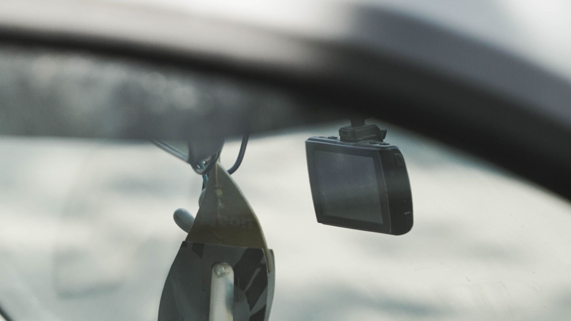 Close-up view of car interior featuring dashboard decor and gadgetry.