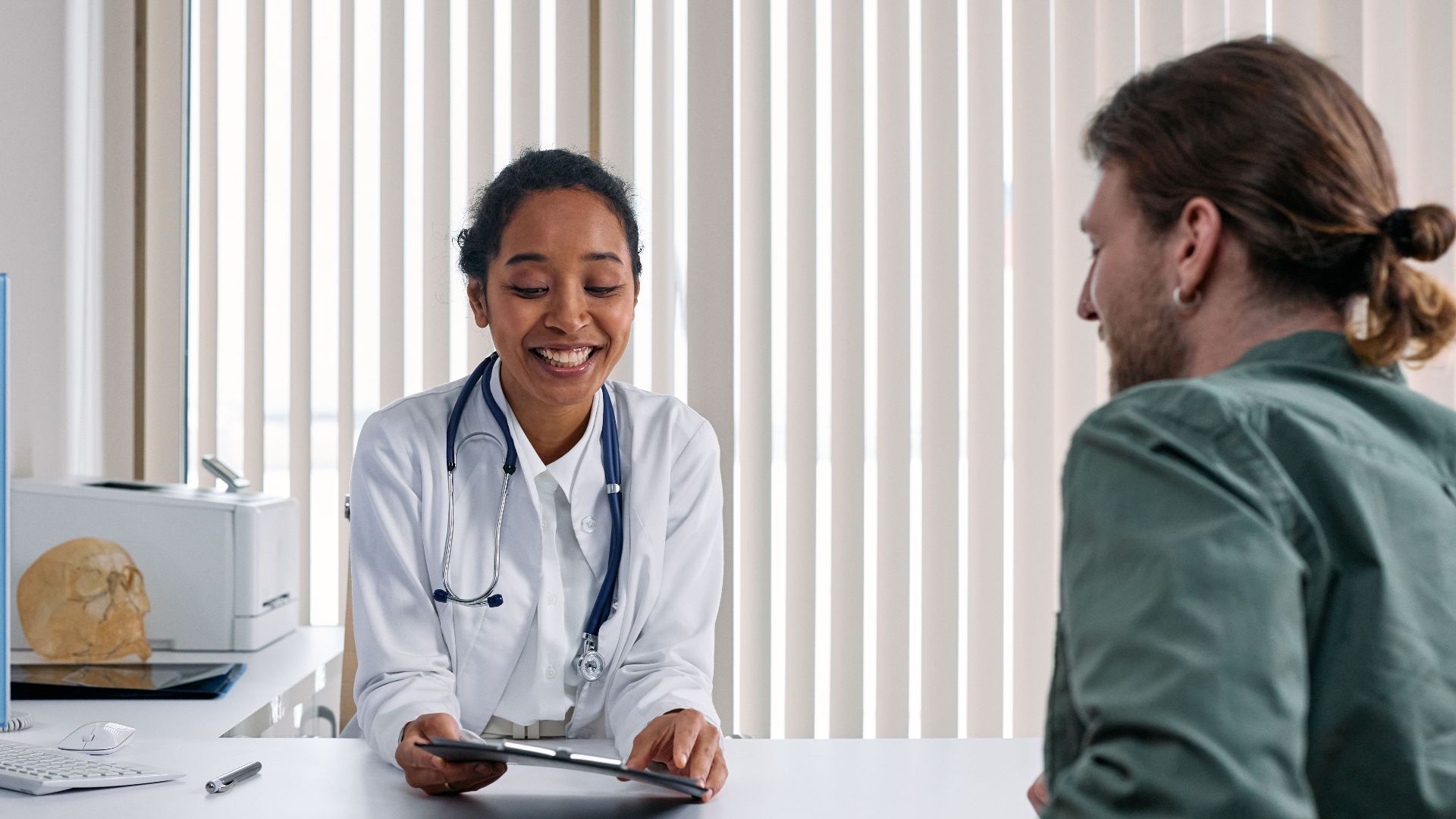 A doctor and patient engaging in a positive consultation in a bright clinic setting.