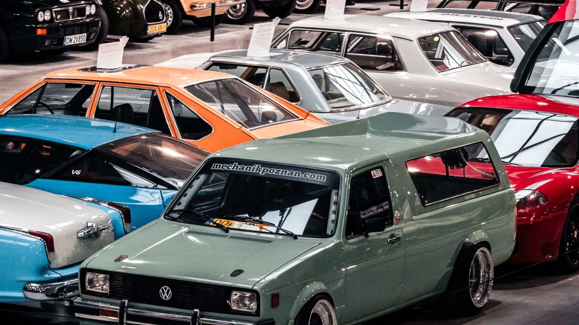 Showcase of vintage cars at an indoor exhibition in Oława, Poland.