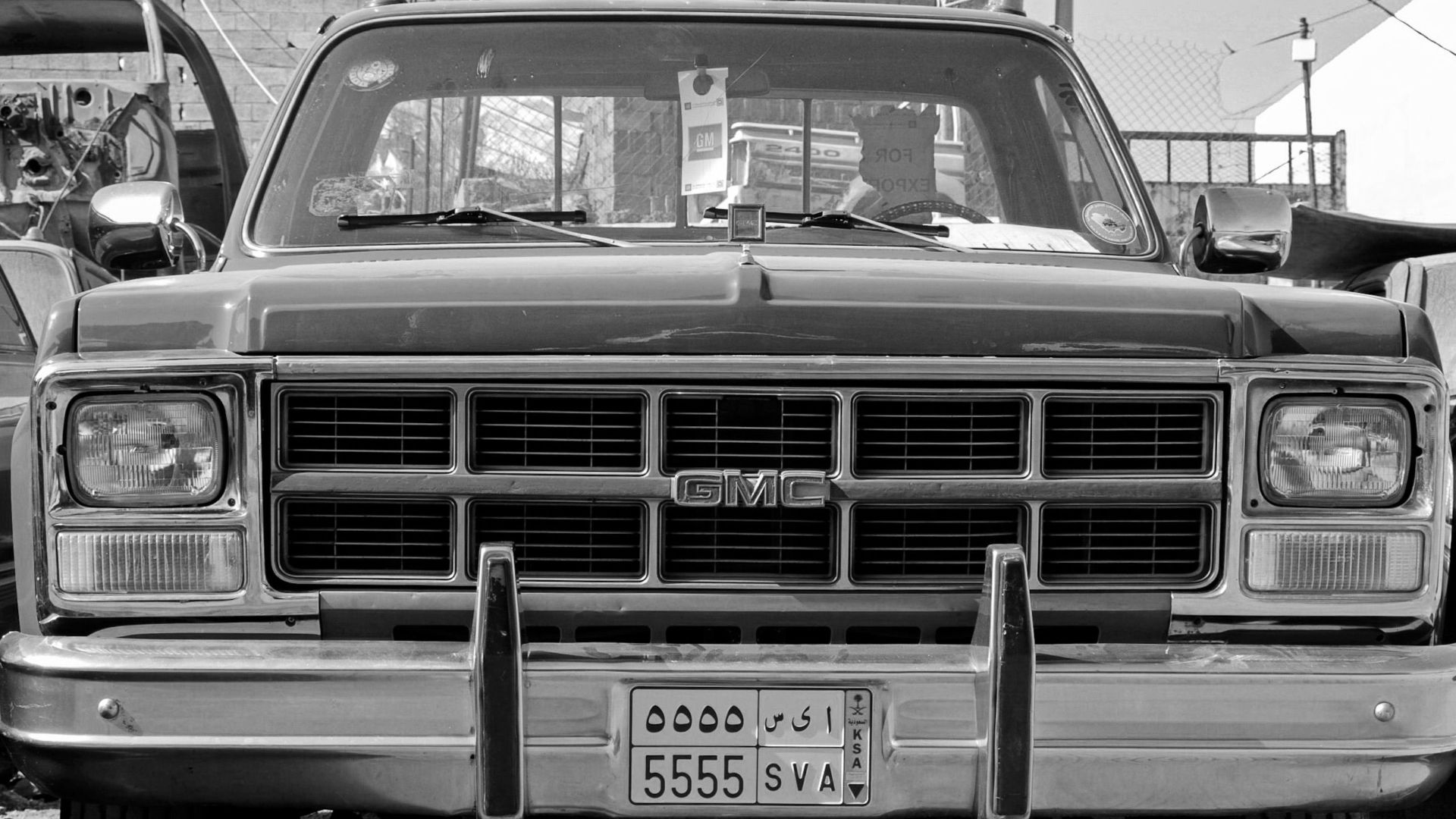 Front view of a classic GMC vehicle in black and white, showcasing vintage design.