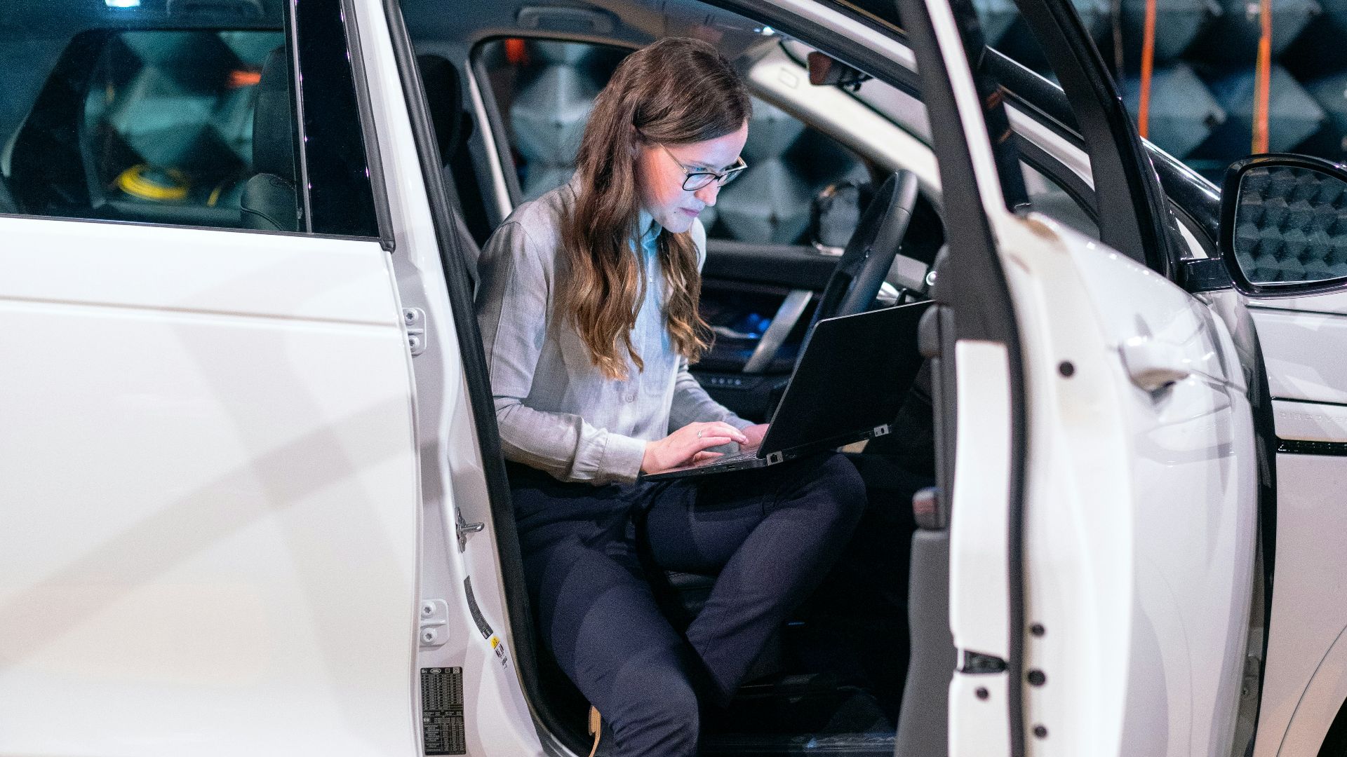 woman in white long sleeve shirt sitting on white car