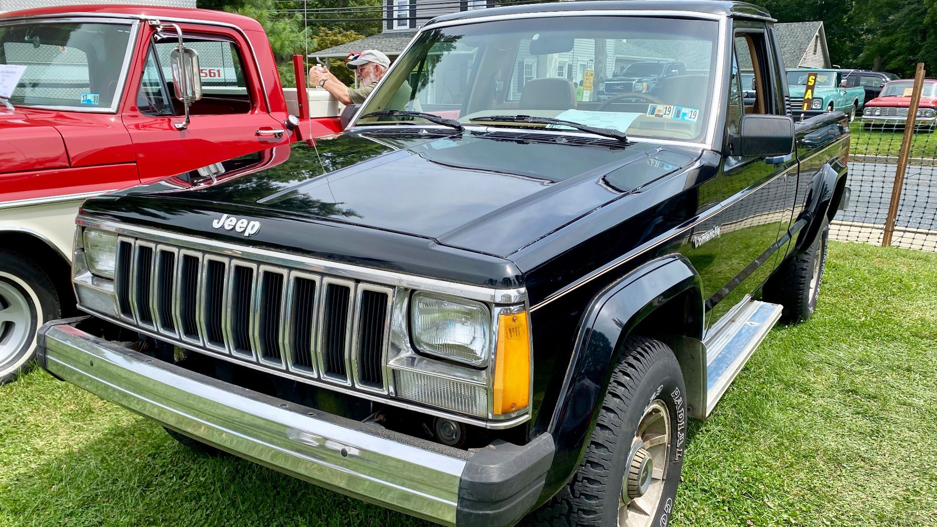 1987 Jeep Comanche pickup truck finished in black. The Interior is tan with bucket seats and a center console with automatic transmission. Note, this has aftermarket side running boards and a custom rear bumper.
These pictures were taken at the 2021