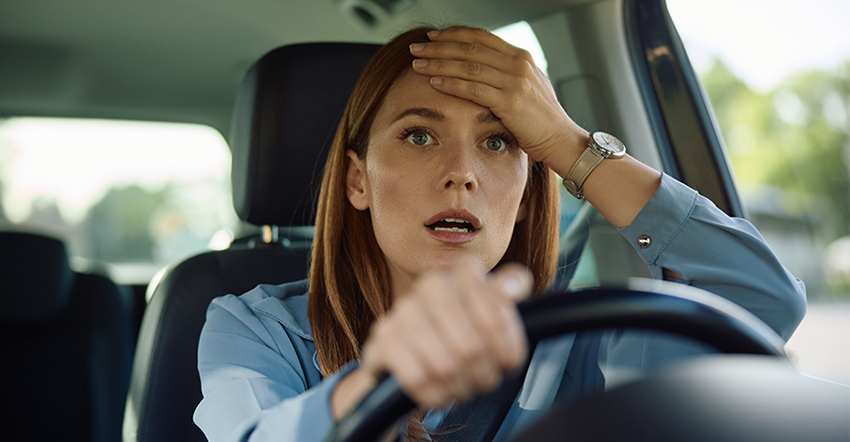 Shocked businesswoman driving a car