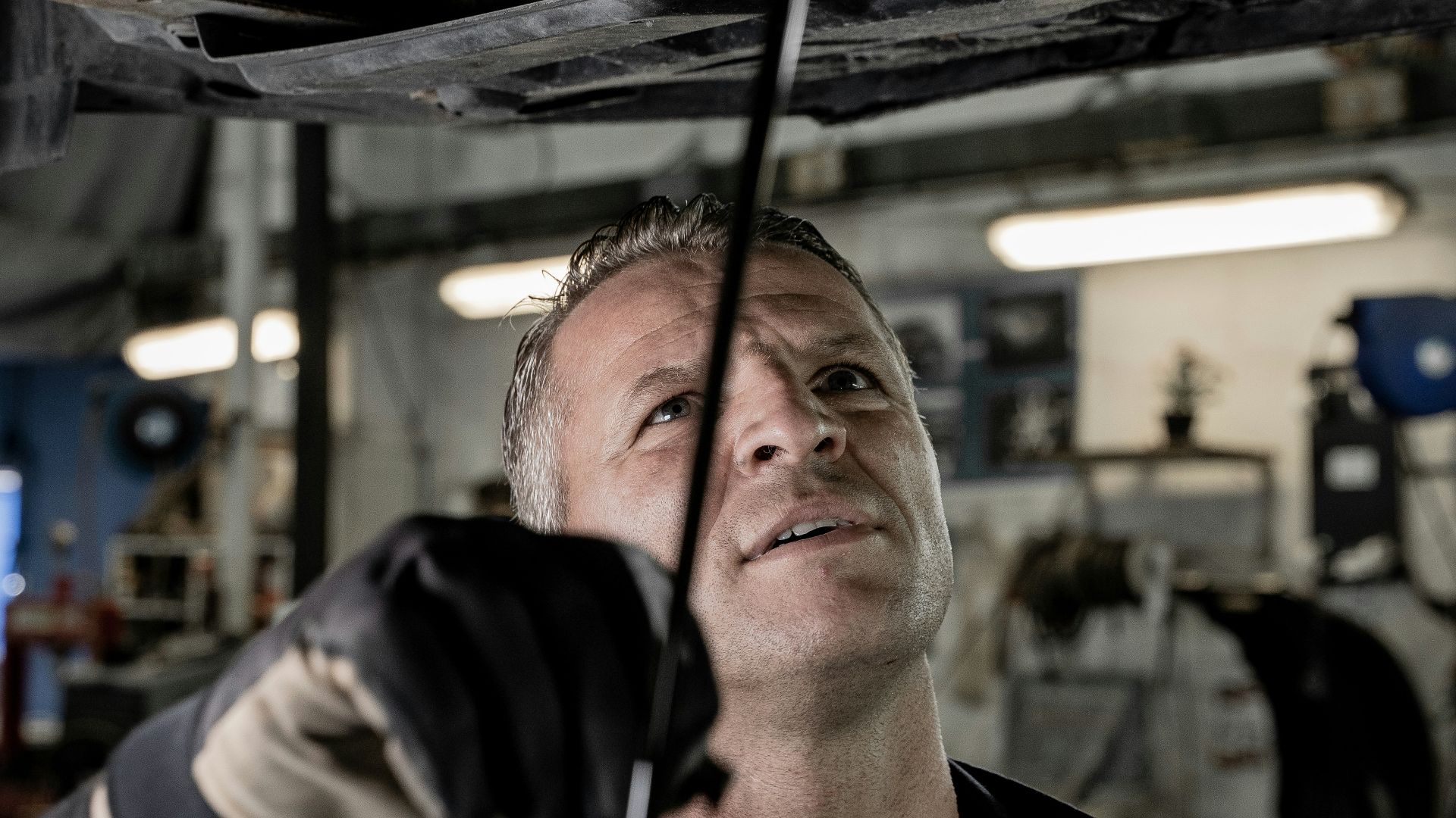 a man working on a car in a garage