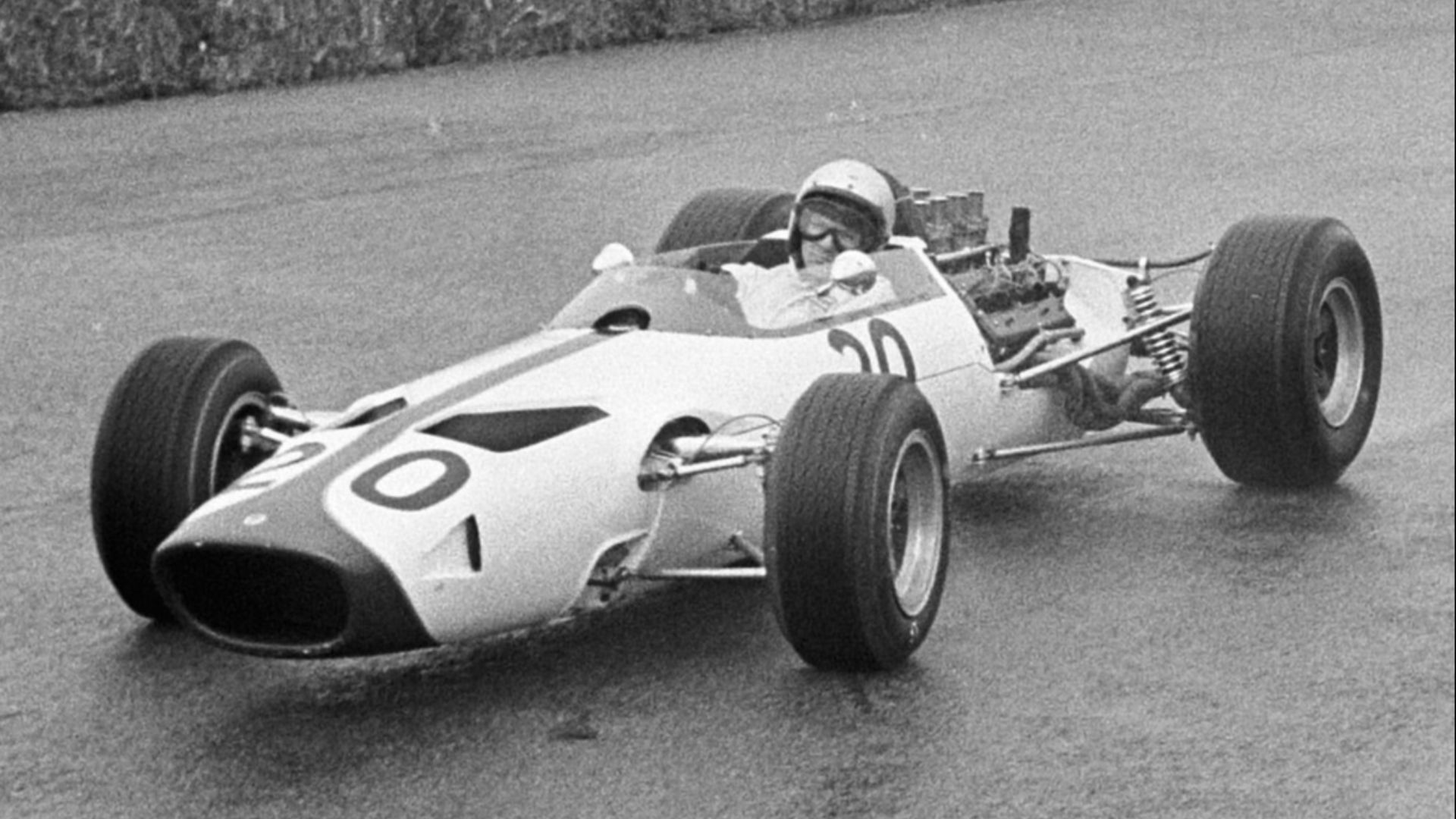 Bruce McLaren (McLaren M2B; #20), Jo Siffert (Cooper T81; #28) and Dan Gurney (Eagle T1G; #10) drive in practice for the 1966 Dutch Grand Prix at the Zandvoort circuit.