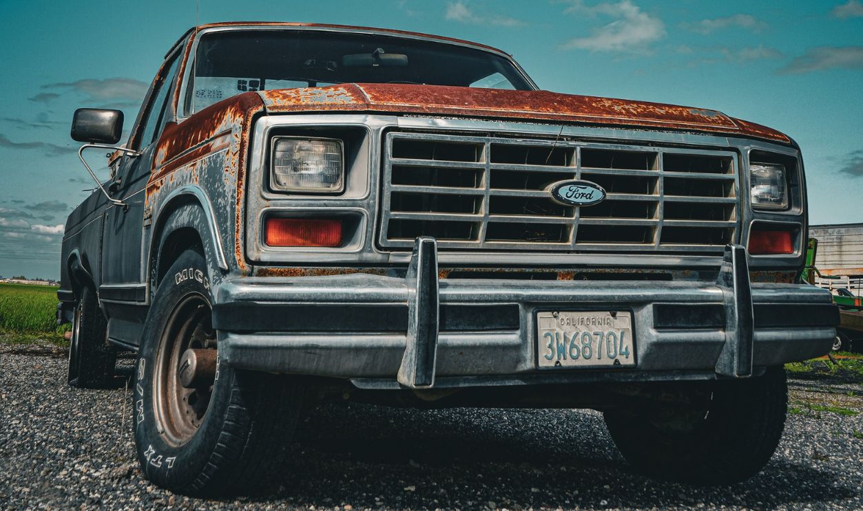 A classic rusty pickup truck parked outdoors