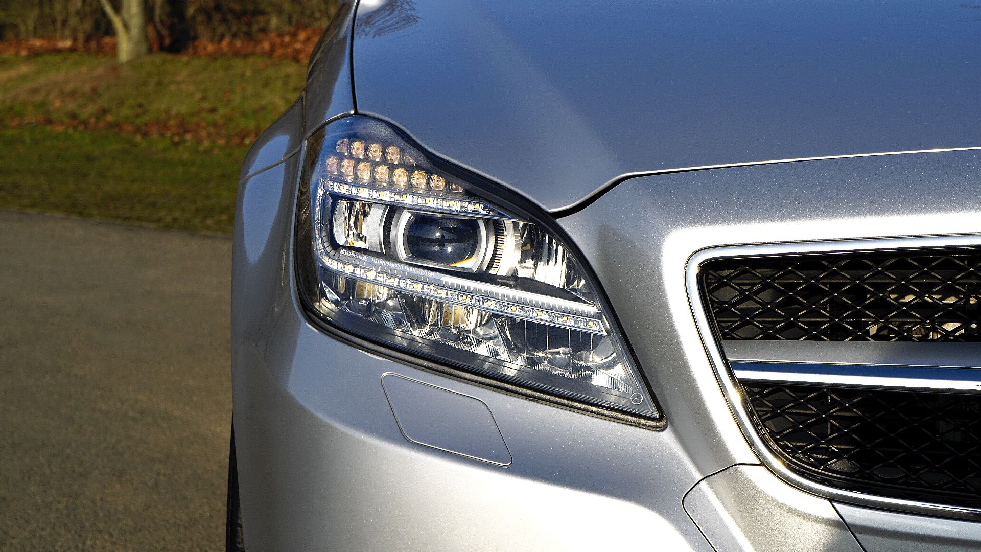 High-quality image of a silver luxury car with a focus on the headlight.