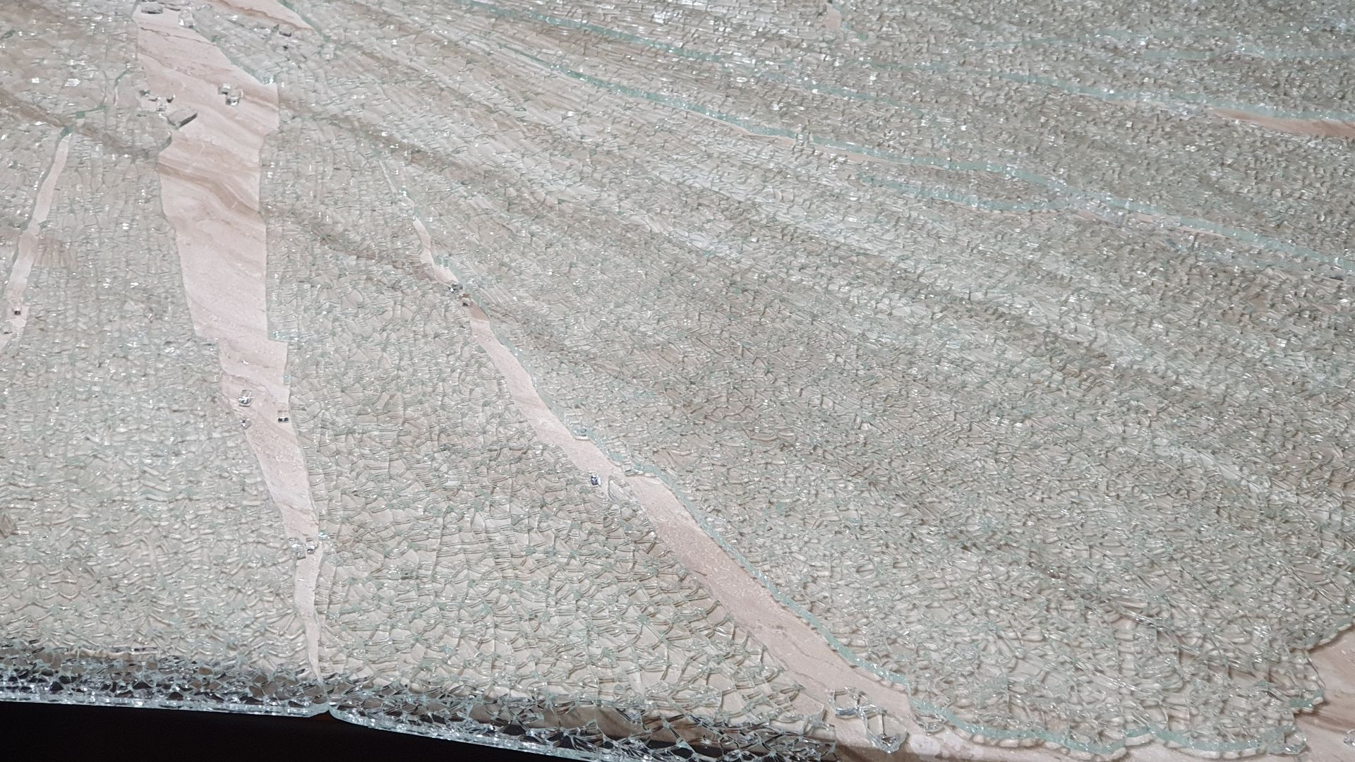 Impurities in the tempered glass can break on its own.