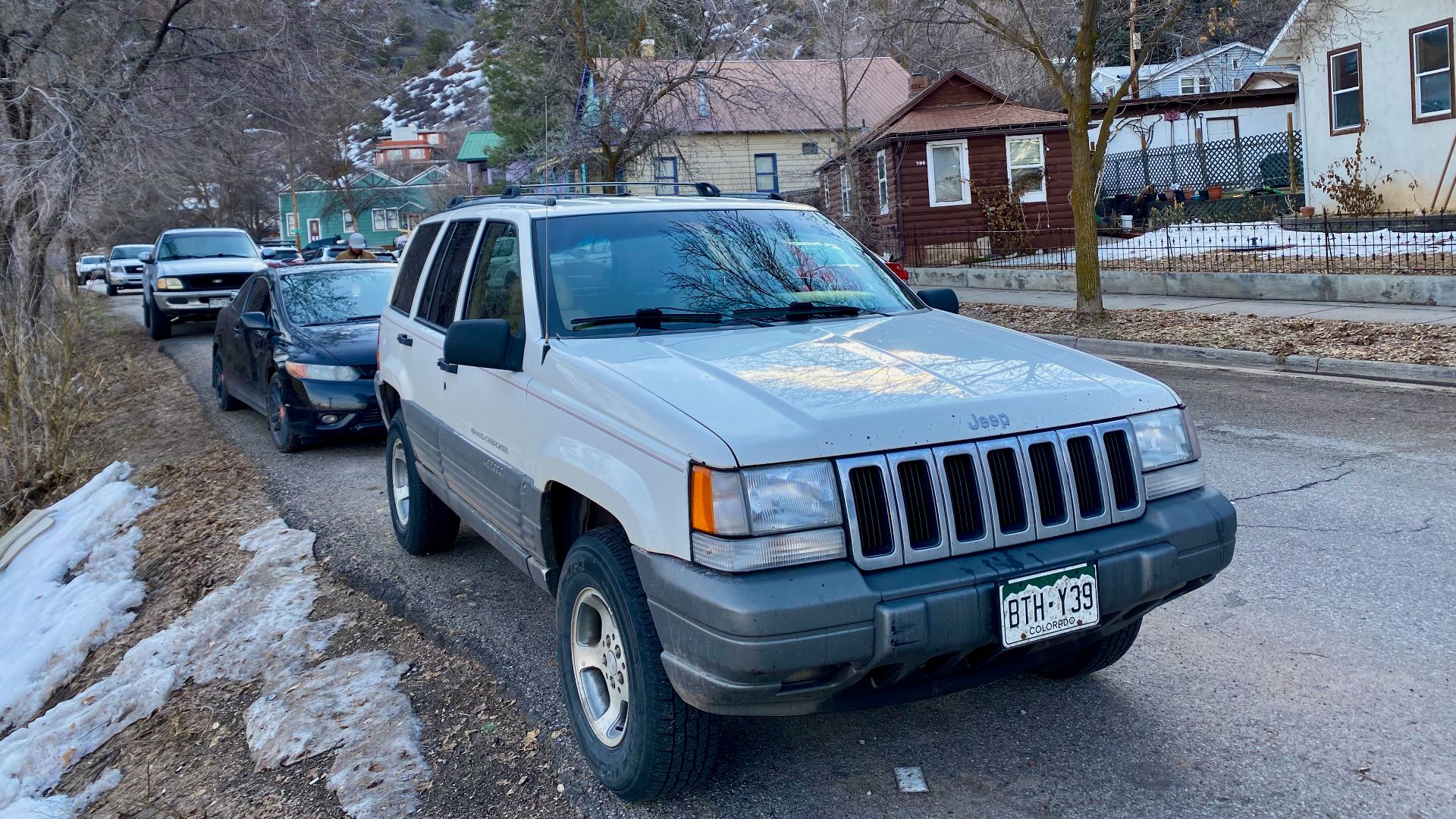 1997 Jeep Grand Cherokee Laredo. A luxurious sport utility (SUV) finished in white and powered by 5.2 L Magnum V8 engine.