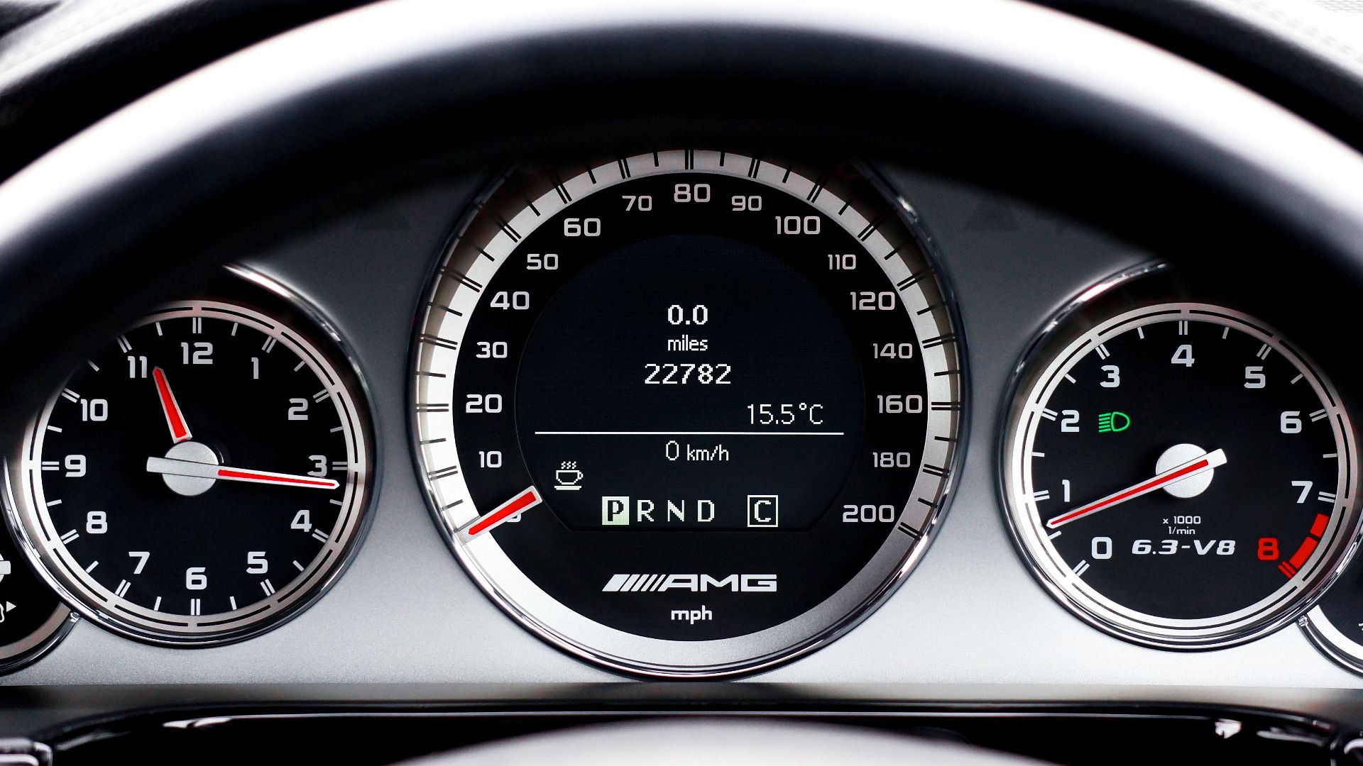 Detailed close-up of a vehicle dashboard featuring modern speedometers and controls.
