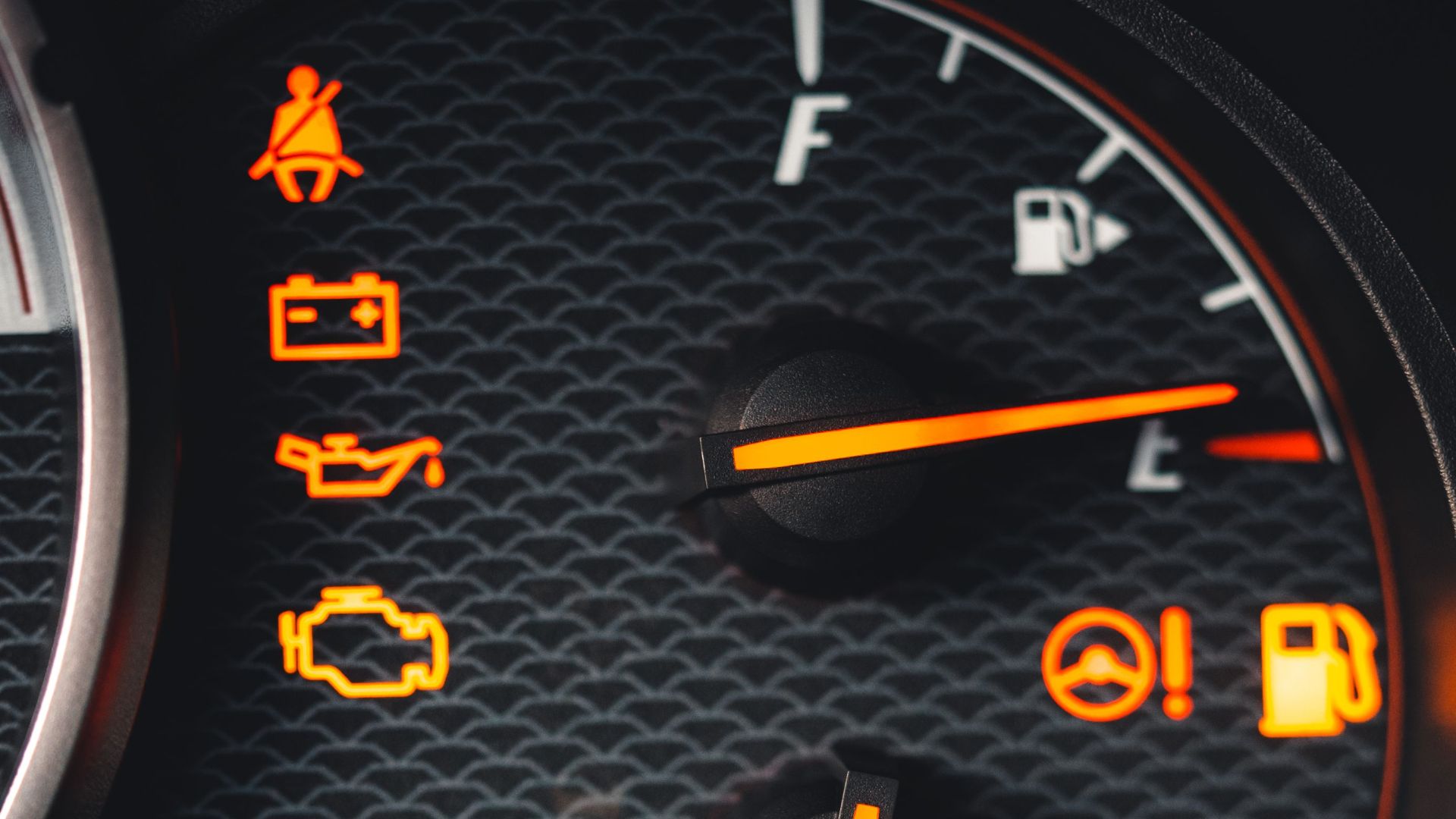 Detailed close-up of car dashboard with various warning lights illuminated.
