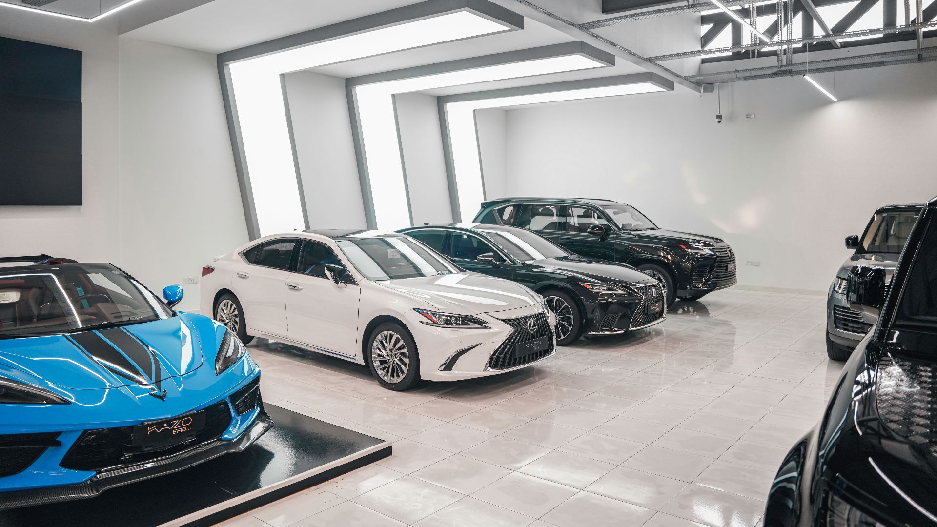 Sleek luxury cars showcased in a stylish, modern automotive dealership.
