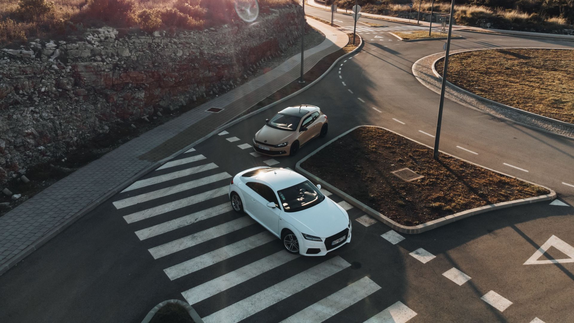 Aerial shot of cars on a road at sunset in Tivat, Montenegro. Scenic landscape and quiet urban scene.