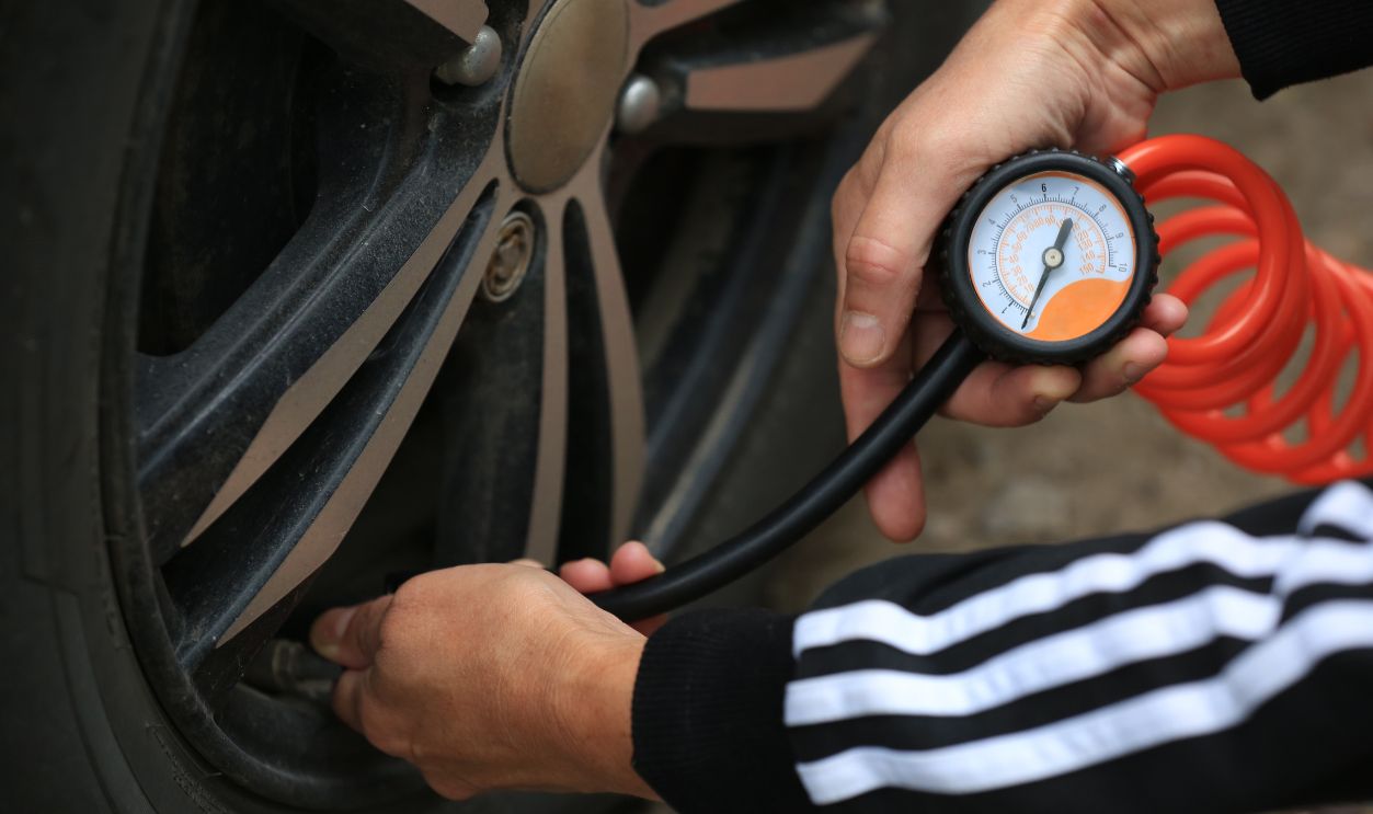 Poland, Gdansk - August 23, 2025 - Inflating Wheels with an Air Compressor