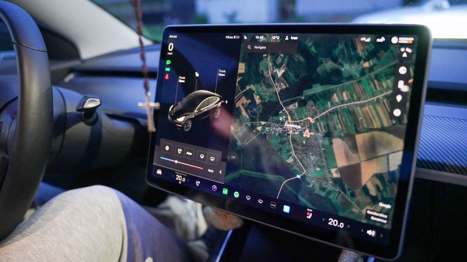 Close-up of a car's digital dashboard displaying GPS navigation in Garešnica, Croatia.