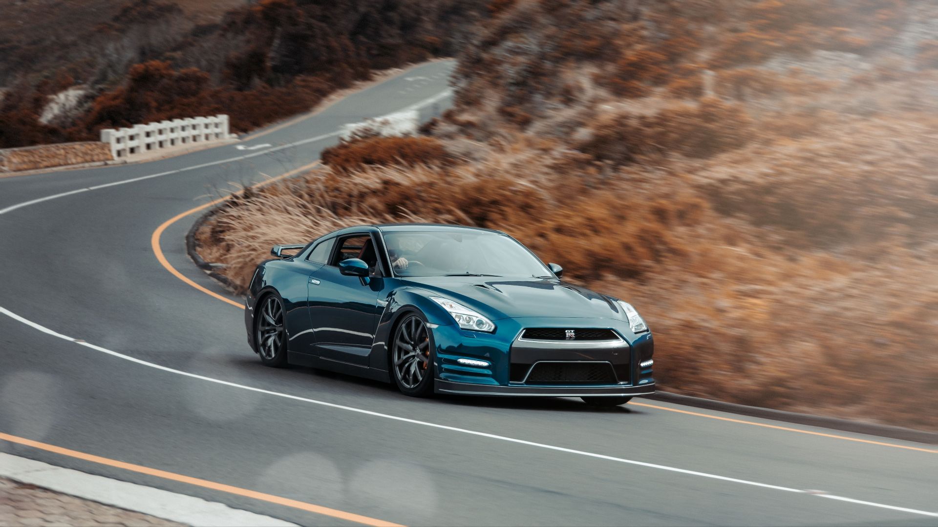 Thrilling drive with a blue sportscar navigating a curvy mountain road in scenic Rooi-Els, South Africa.