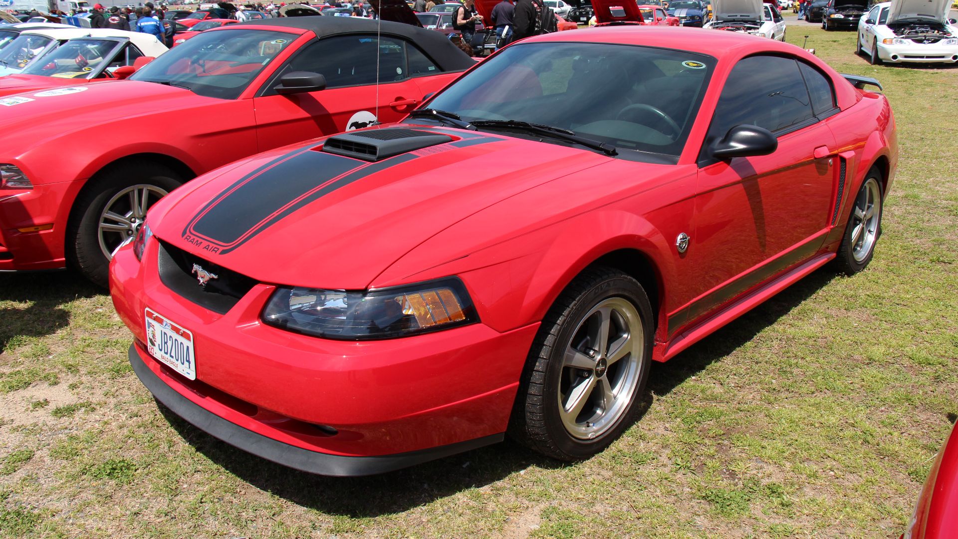 Torch Red. 
An all new 4th generation Mustang, the SN-95, was introduced in 1994, the notchback and hatchback were gone, replaced by a swoopier style coupe, a convertible was also available. The 1999 facelift saw a tougher look with sharper contours. The 