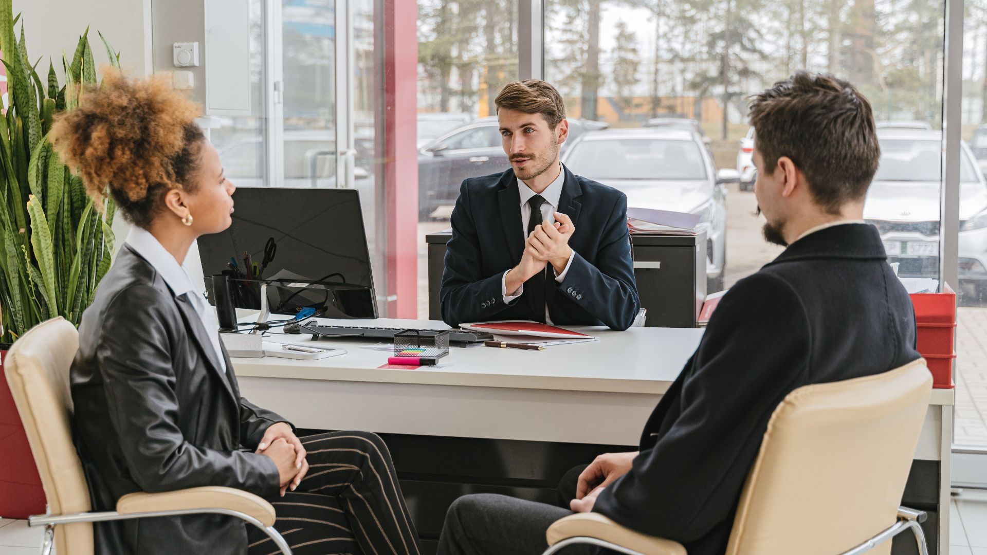 Professional meeting with clients at a modern office, discussing business solutions.