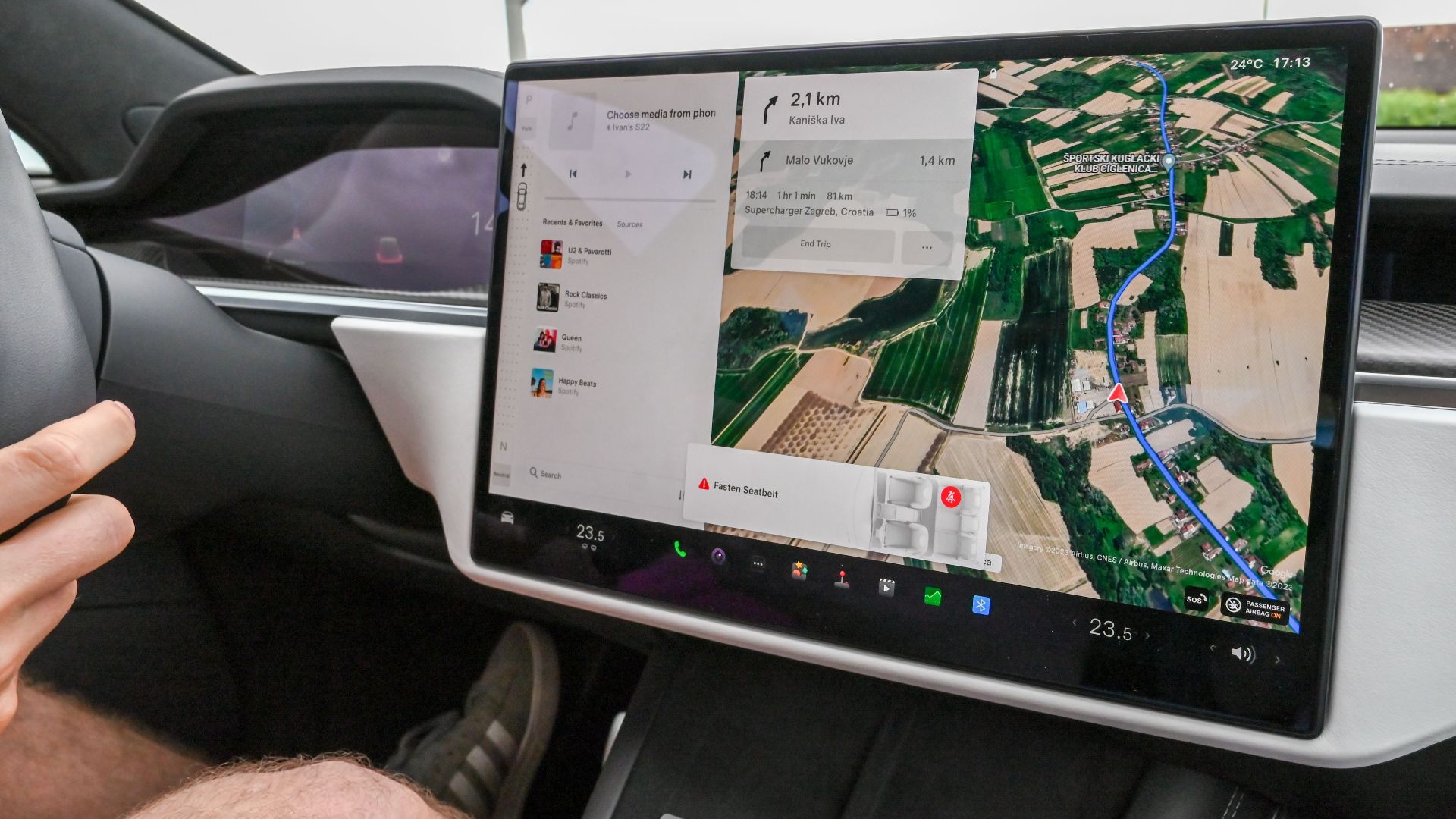 Inside view of a car with a large navigation screen and detailed digital map.