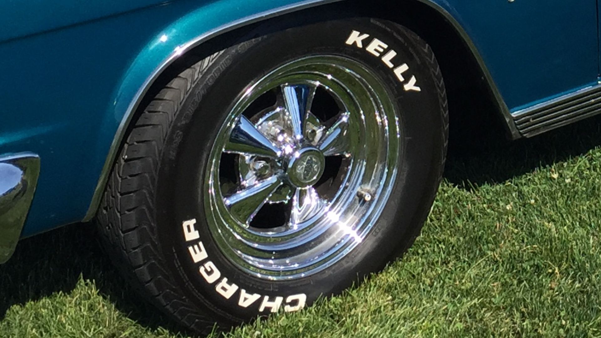 1965 Ramber Marlin fastback, a mid-sized personal luxury car built by American Motors Corporation. Finished in two-tone aqua and white, this car has aftermarket and period-correct Cragar wheels. Picture taken during the American Motors Owners Association