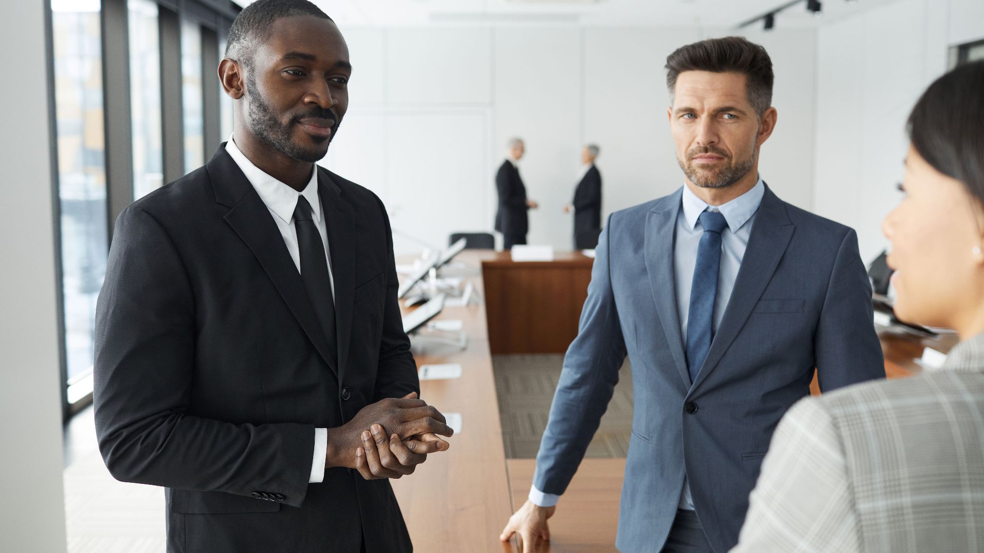 A diverse group of professionals engaged in a business meeting in a modern conference room.