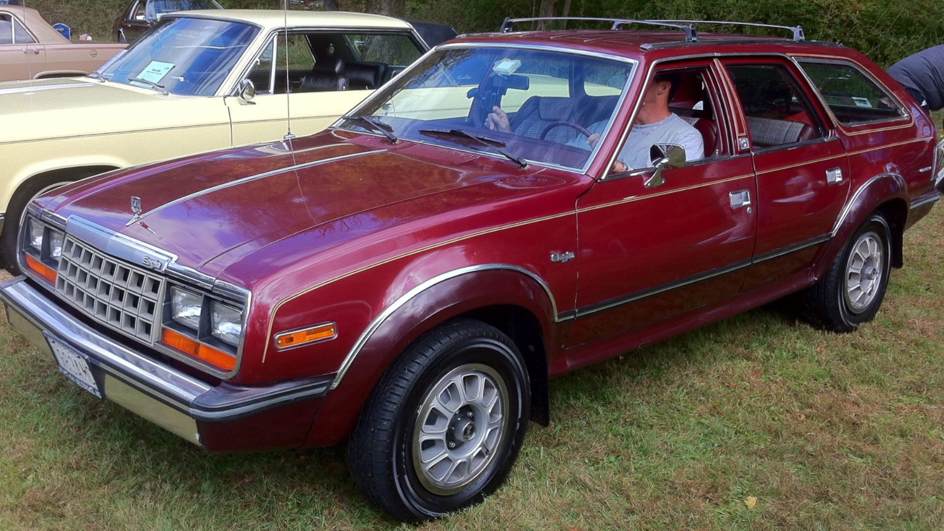 1983 AMC Eagle station wagon, an innovative automatic all-wheel-drive vehicle made by the American Motors Corporation (AMC). Left front view. Base model finished in two-tone red. Picture taken at the annual antique car show sponsored by the City of Rockvi
