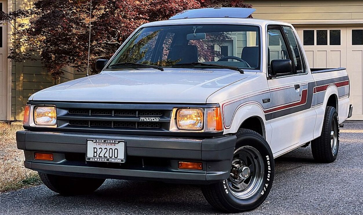 This is my 1989 Mazda B2200 Cab Plus, in Dover White (WU) on Gray (C1) Checkered Tweed. The truck was assembled at Mazda's Hiroshima Plant on November 8, 1988, shipped to the Port of Benicia, California, and sold new at Kevin Del Grande's Almaden Mazda in
