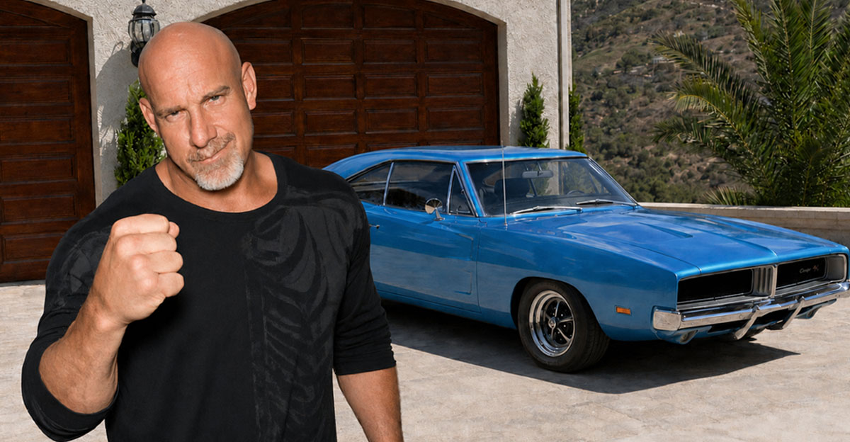 Composite image of actor and former WWE wrestler Bill Goldberg and an AI-generated background featuring a blue 1969 Dodge Charger parked outside a garage 
