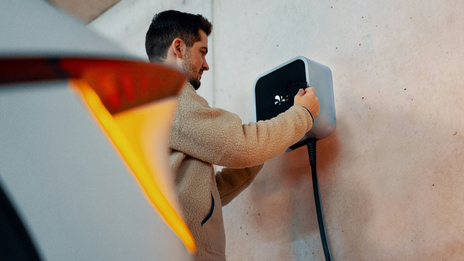 A man is plugging in a car charger