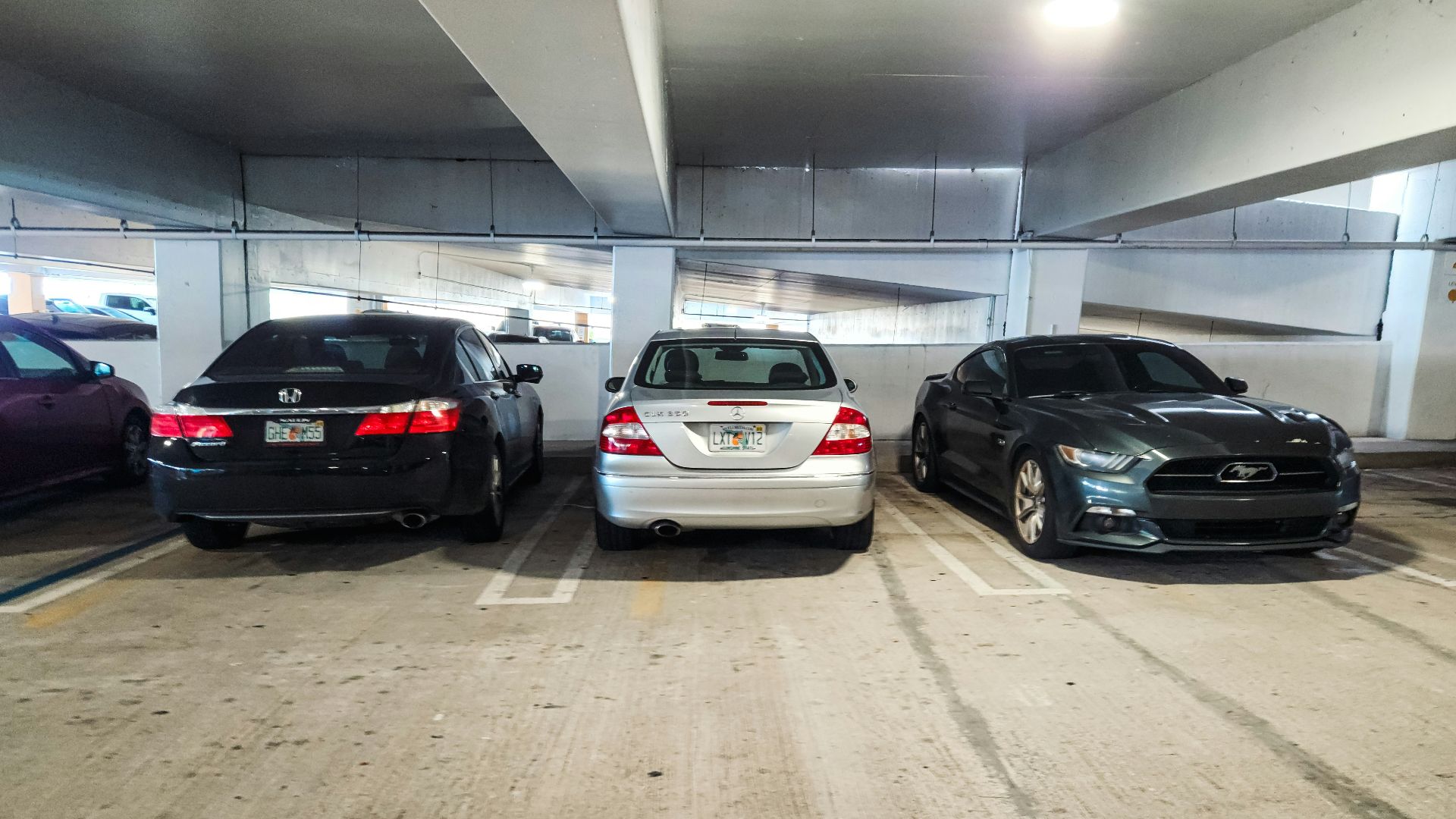 A group of cars parked in a parking garage