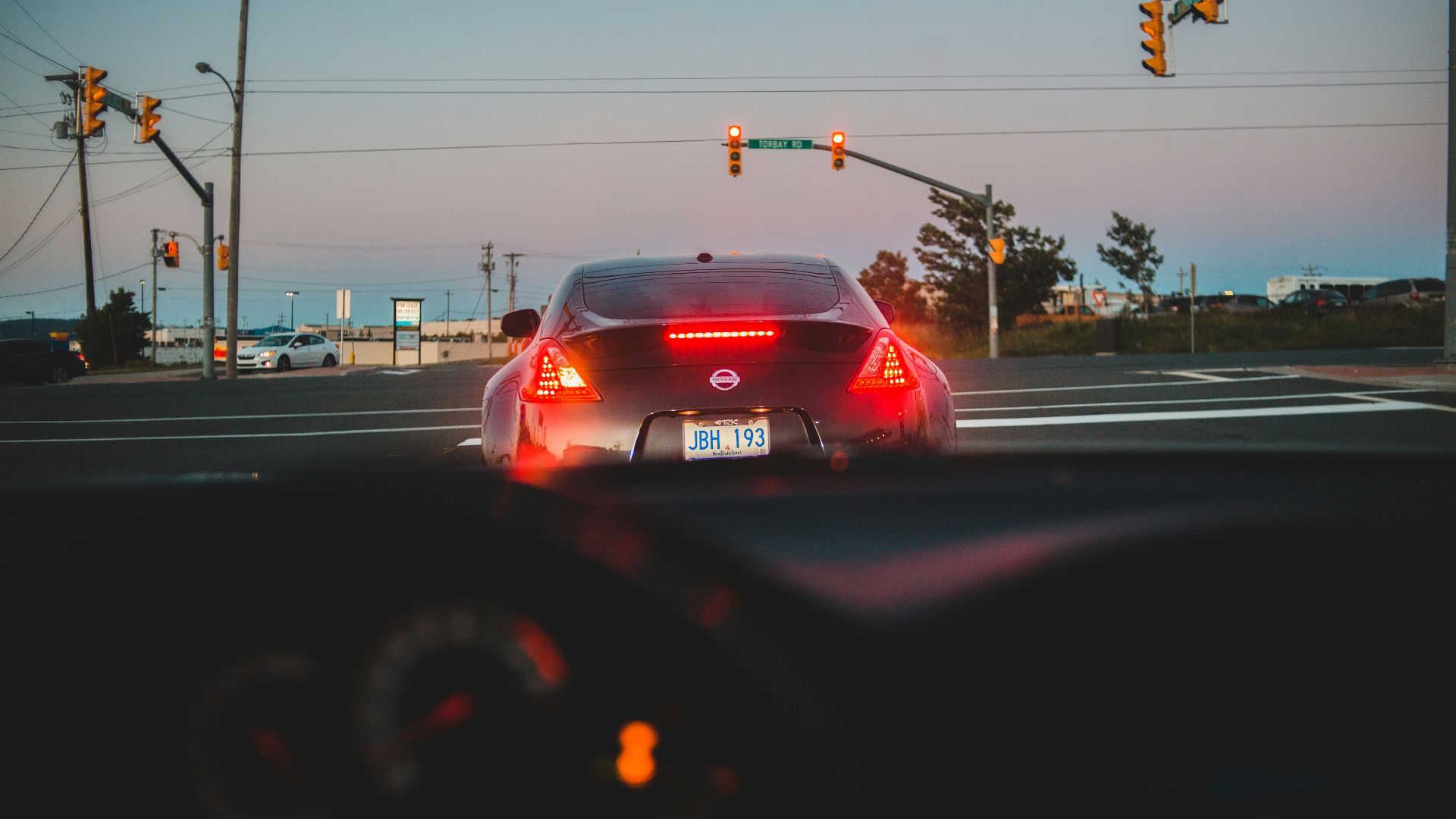 red car on road during daytime