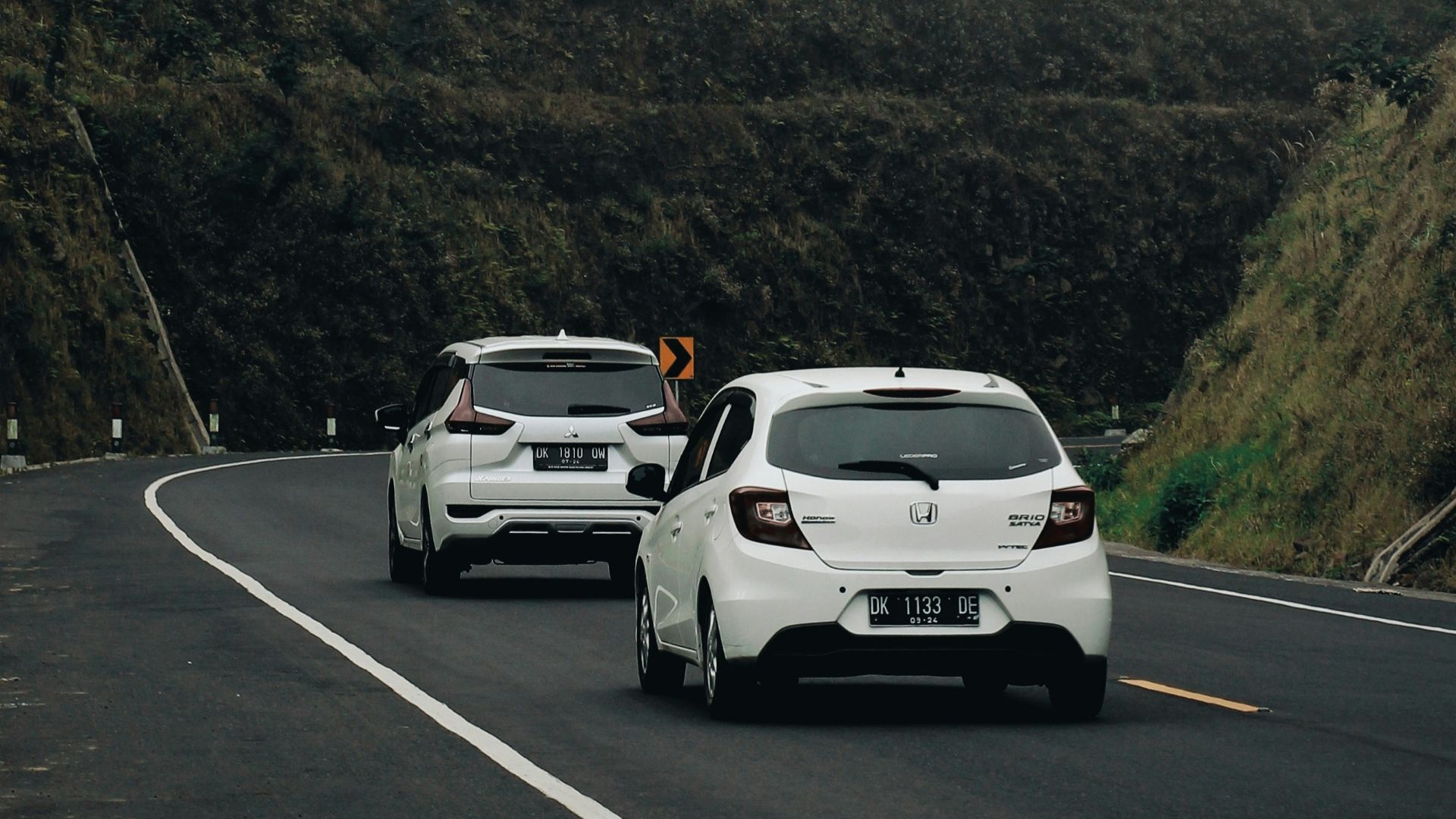 a couple of cars that are sitting in the street