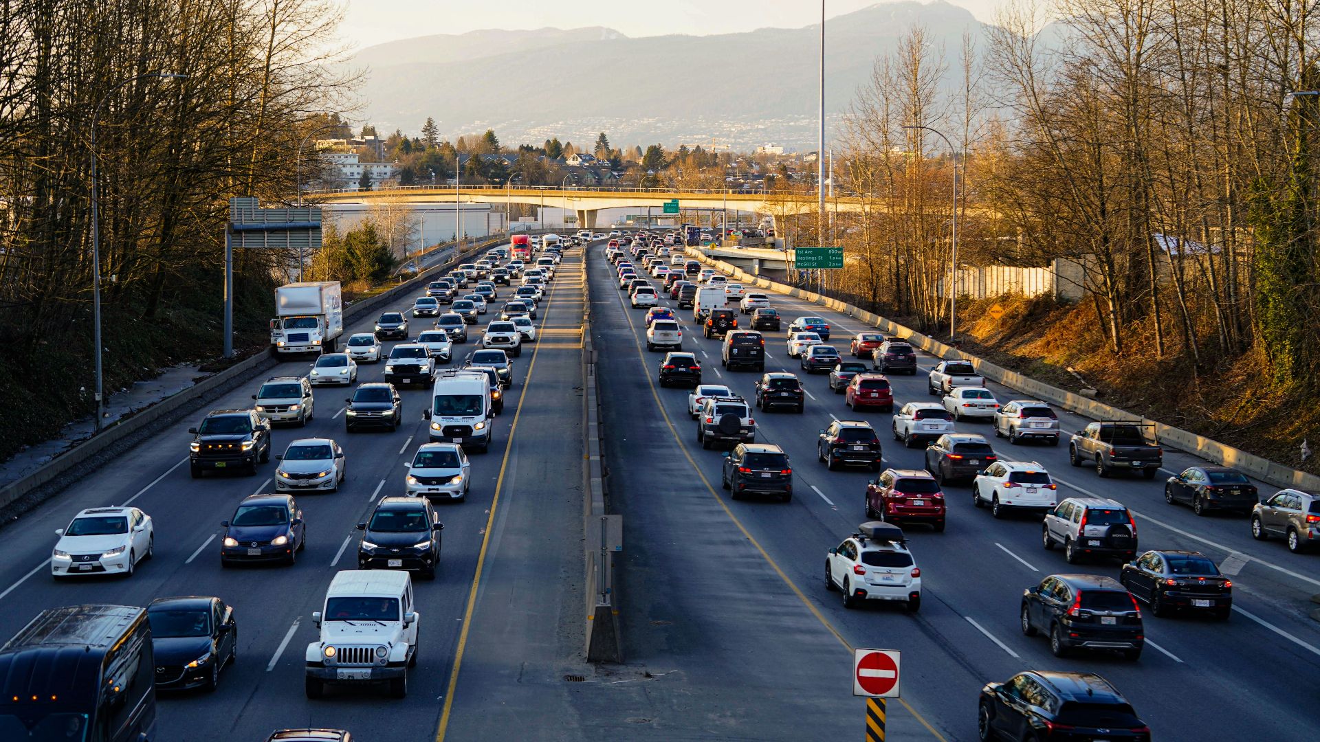 Highway is experiencing heavy traffic with many cars.