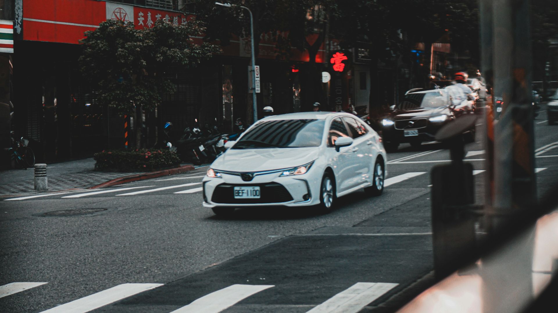 white sedan on road during daytime