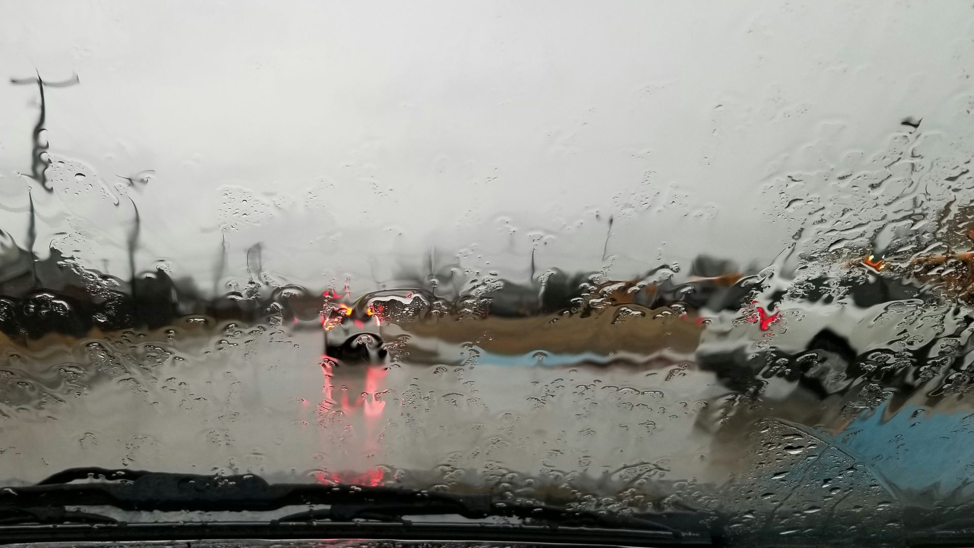 vehicle running on road during rainy