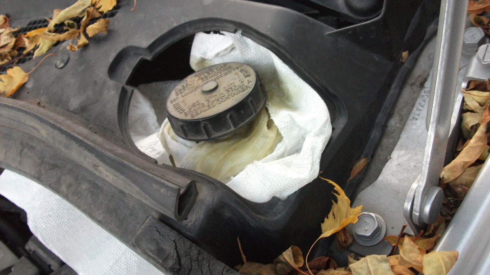 Loosen brake res cap lid a bit. When pushing in the caliper pistons a little fluid make leak out - I put out so paper towel to catch it.