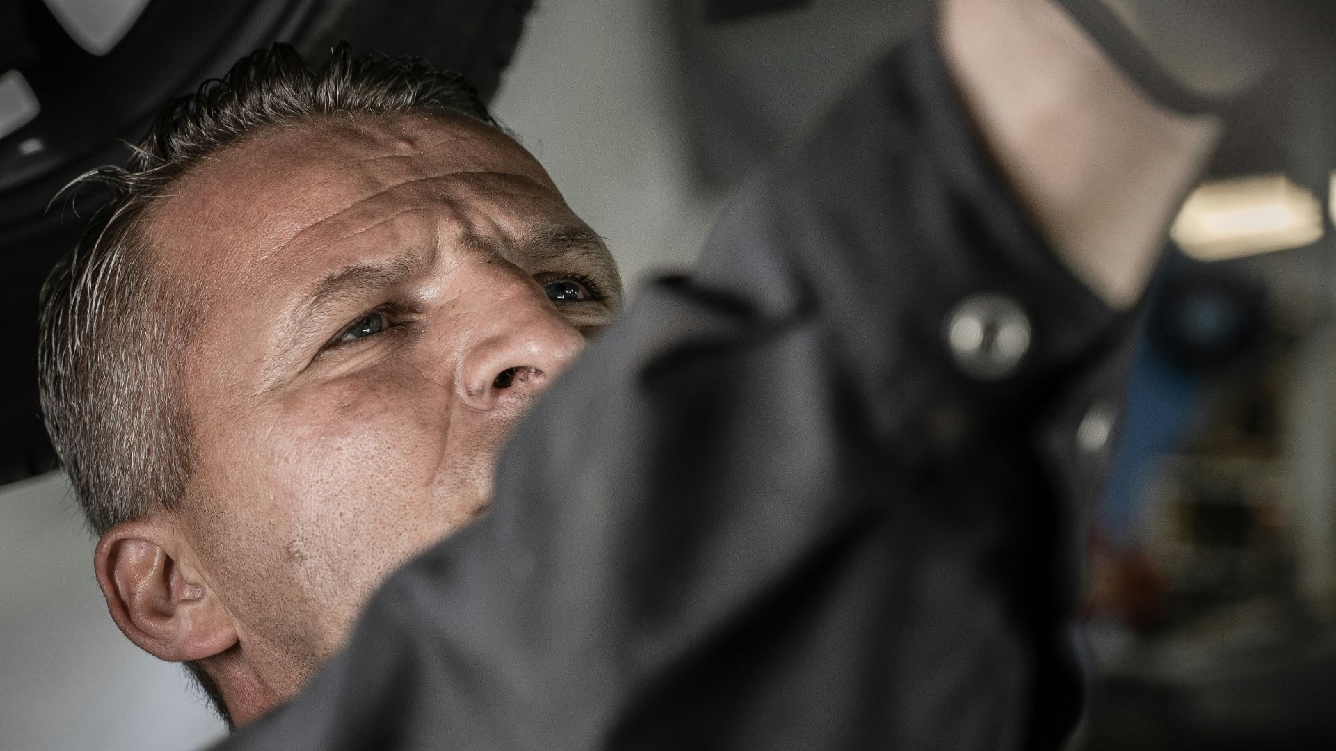 a man working on a car under a vehicle