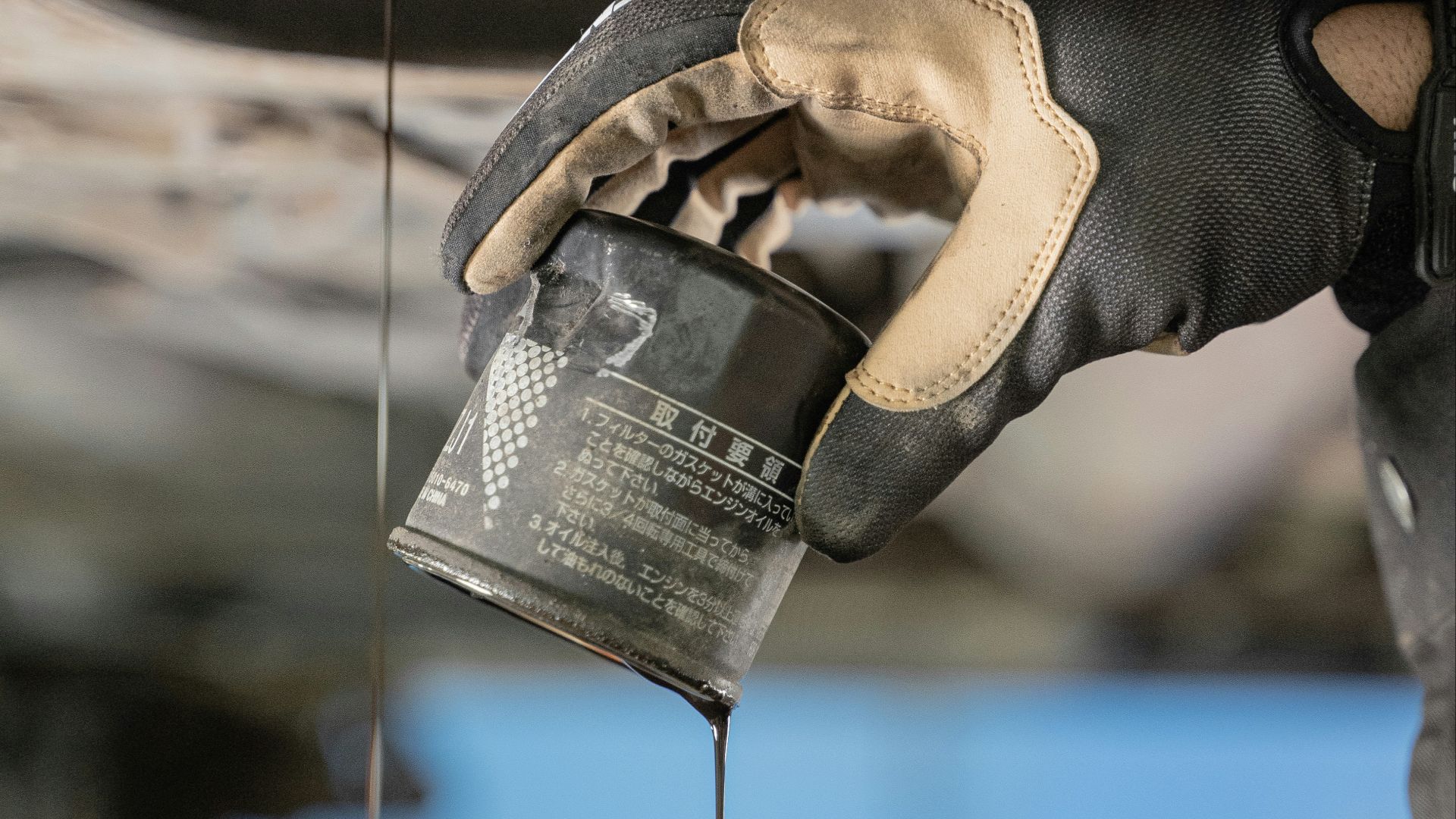 a mechanic is pouring oil on a car