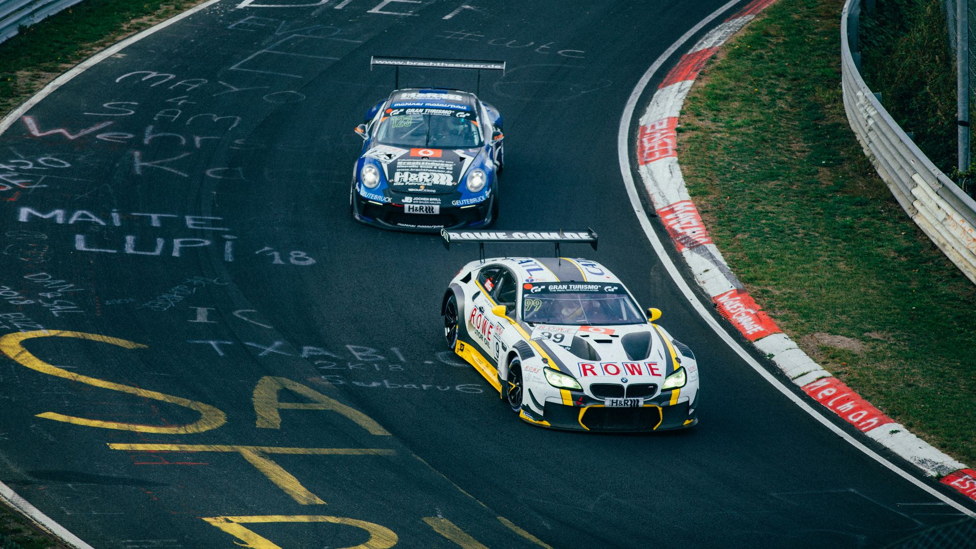 Two running cars on race track