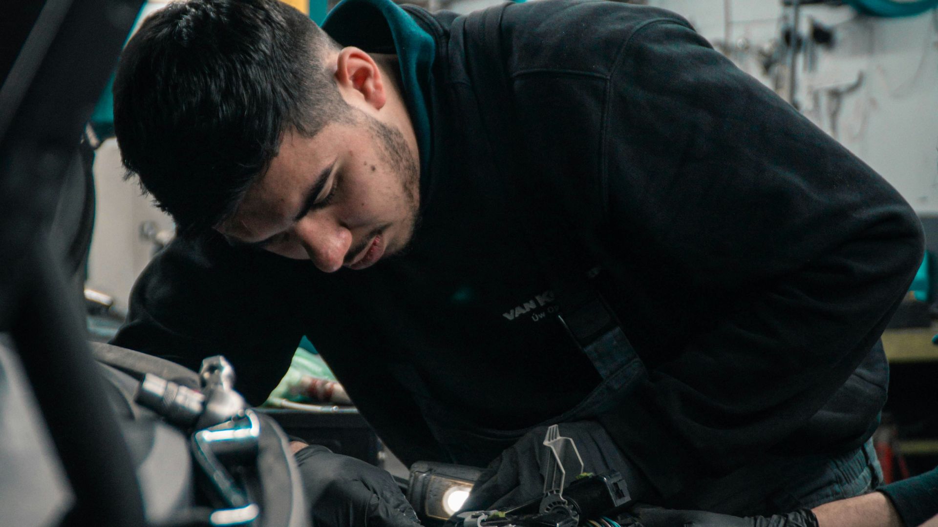 mechanic working on car engine