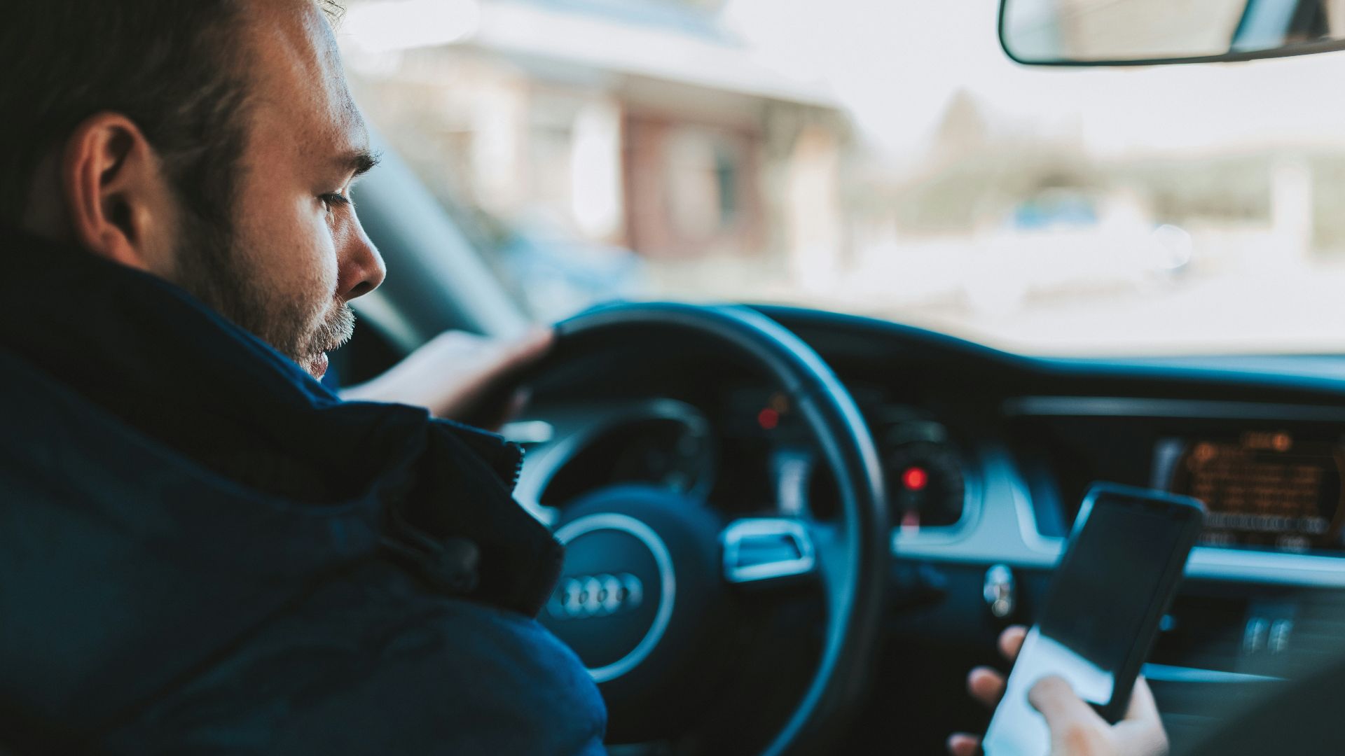 man holding black smartphone