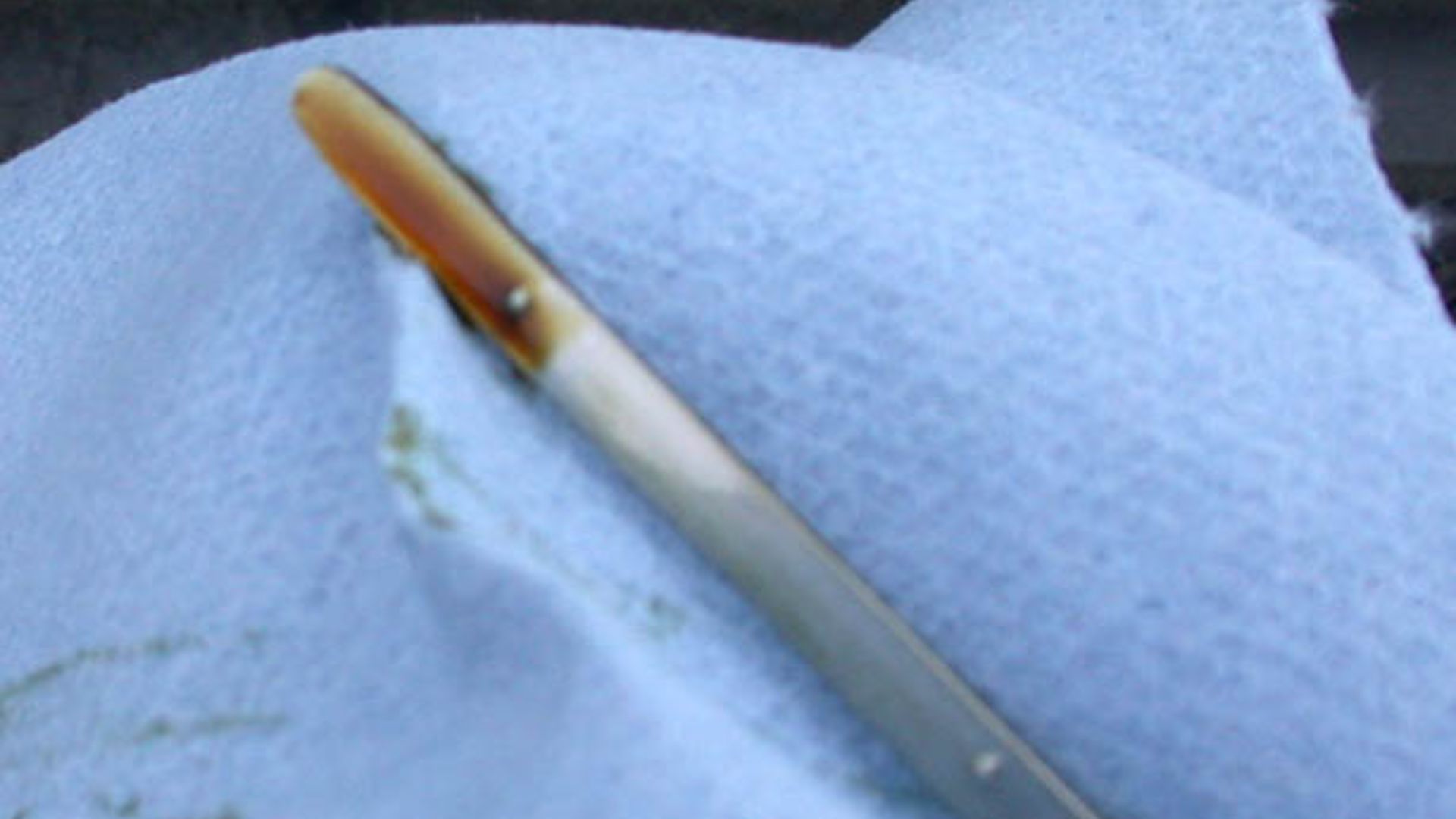 Dipstick for measuring the level of motor oil in an automobile.