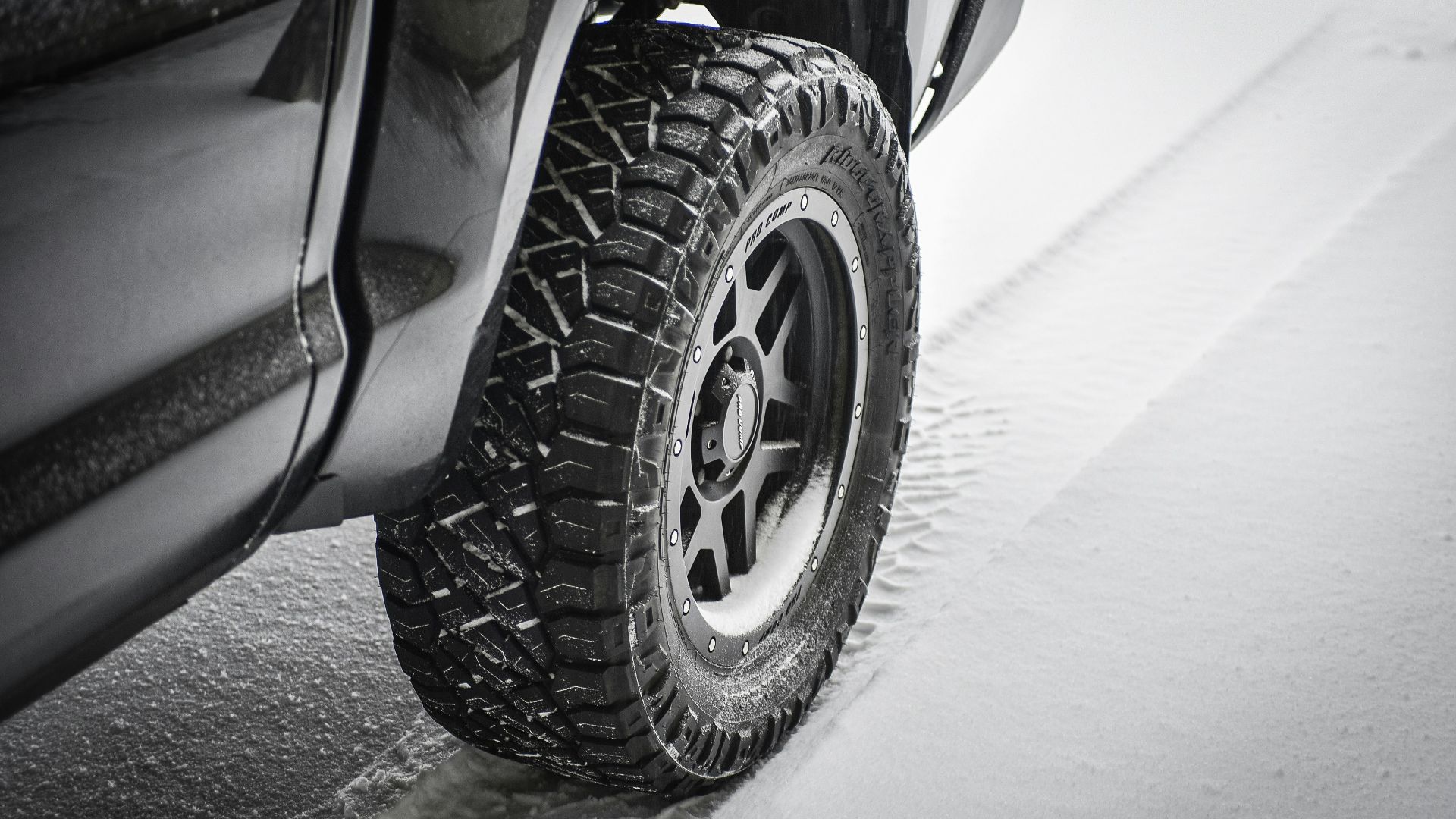 grayscale photo of car wheel